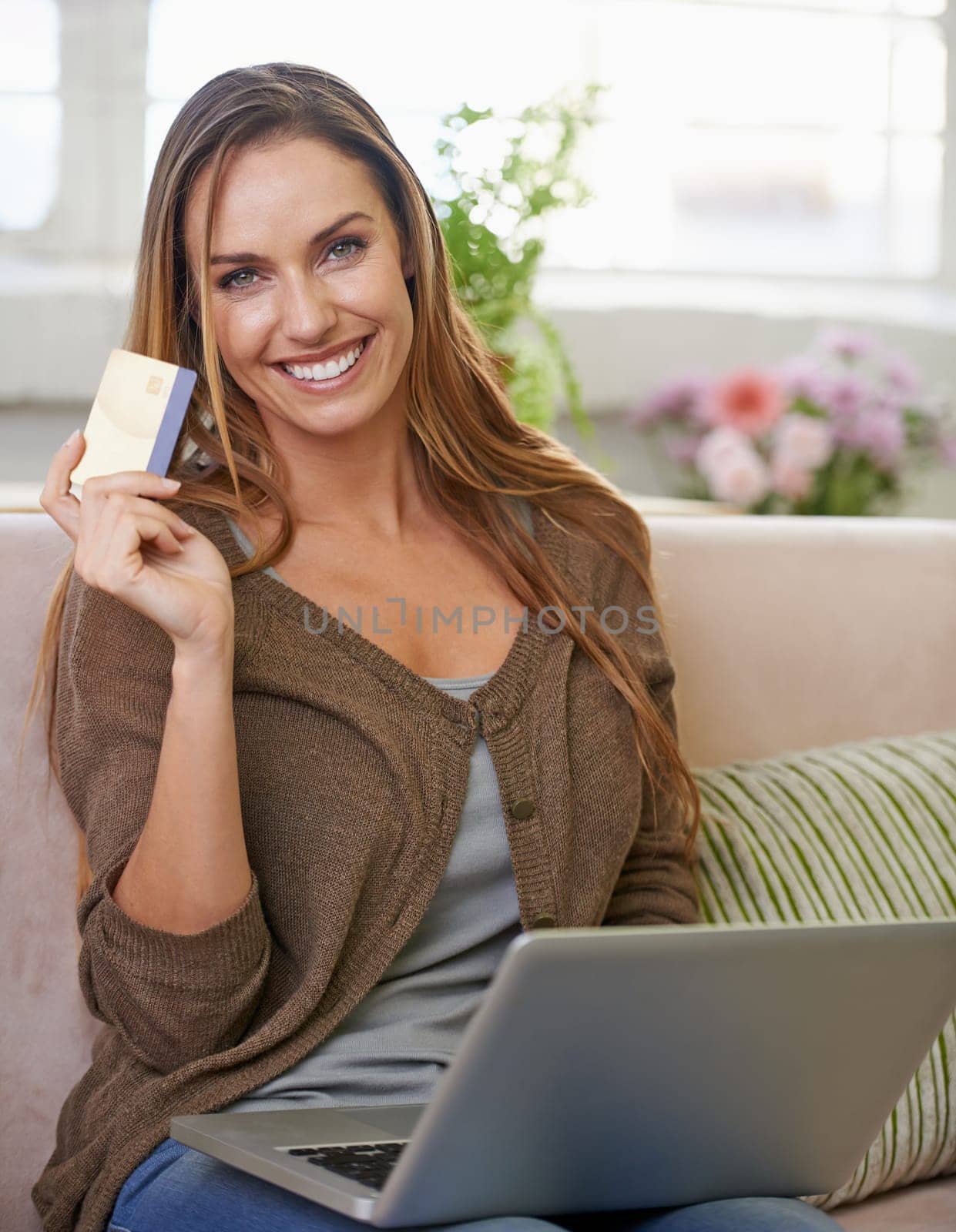 Woman, portrait and credit card with laptop for online shopping in apartment for ecommerce, internet banking or payment. Female person, face and couch for web finance or tech, budget or investment.