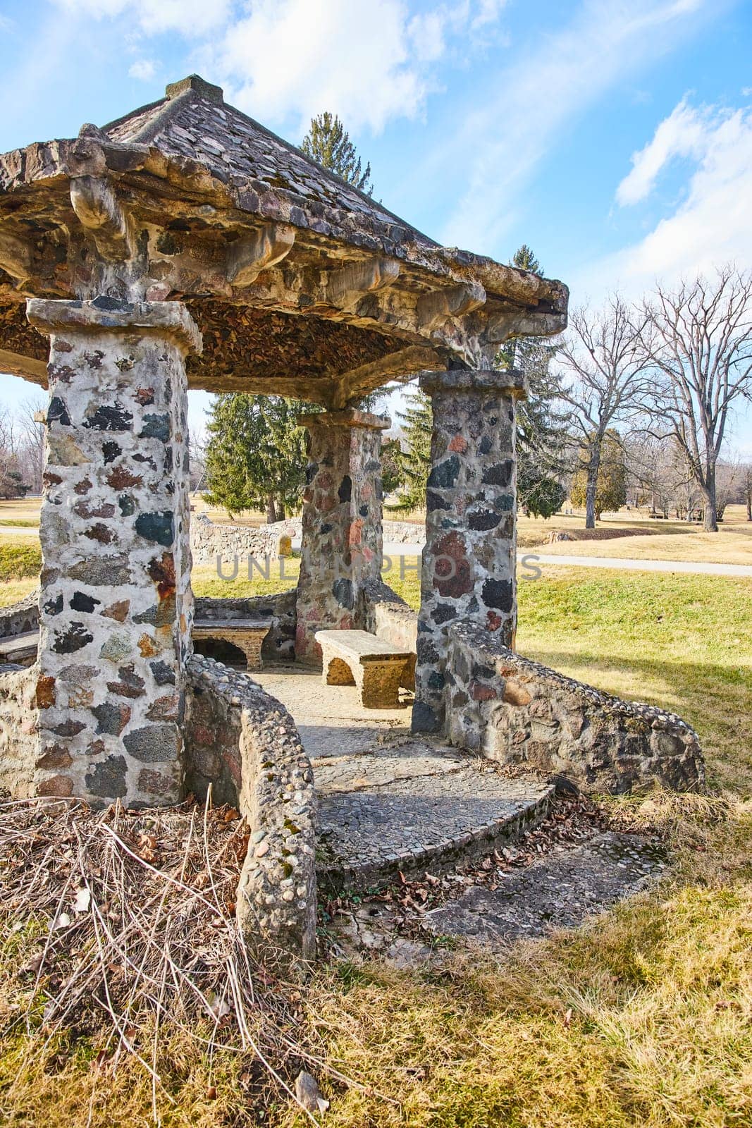 Rustic stone gazebo in tranquil Lindenwood Cemetery, Fort Wayne, Indiana - a serene winter retreat for reflection and history