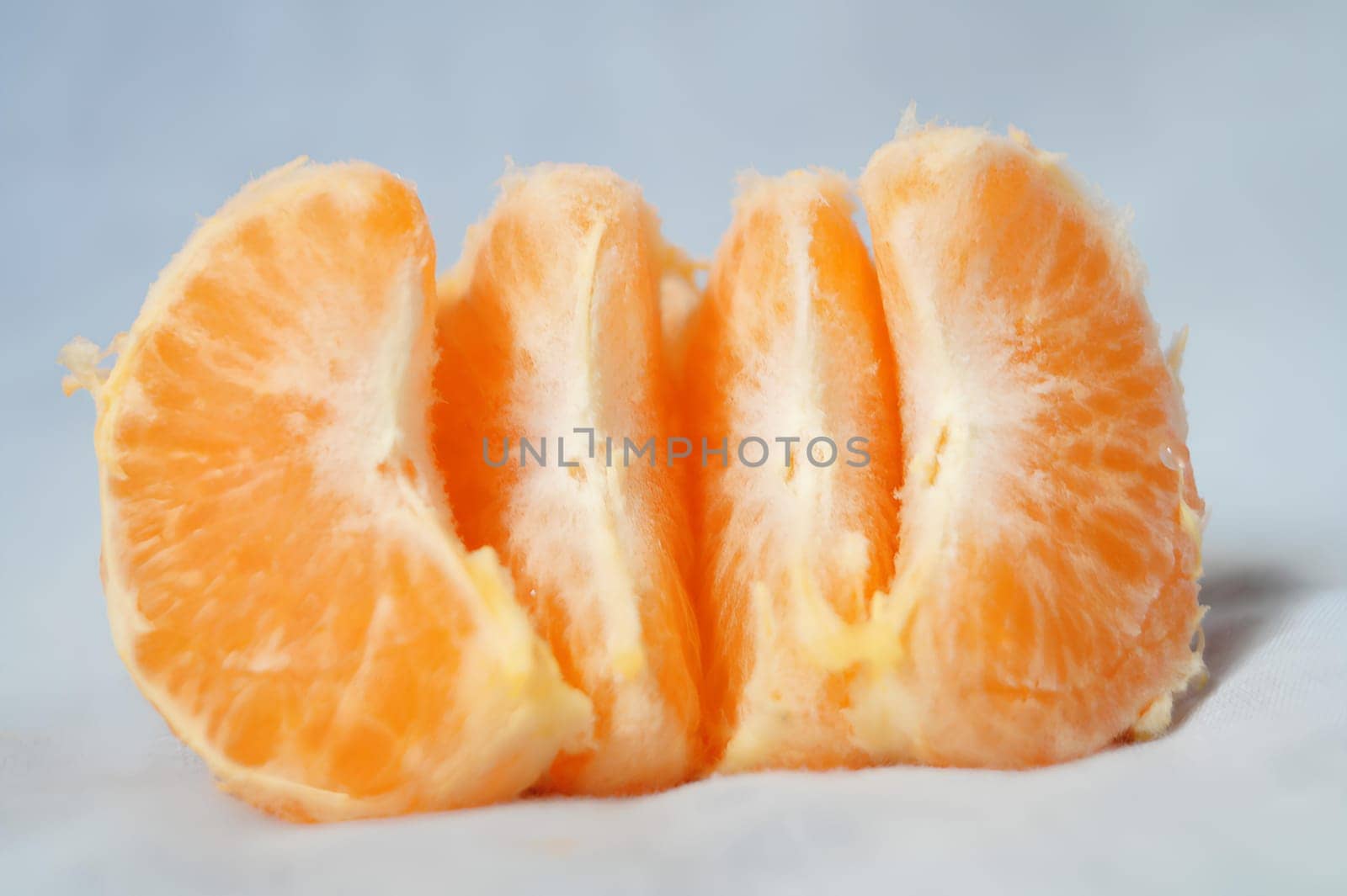 A peeled orange with the top cut off. High quality photo