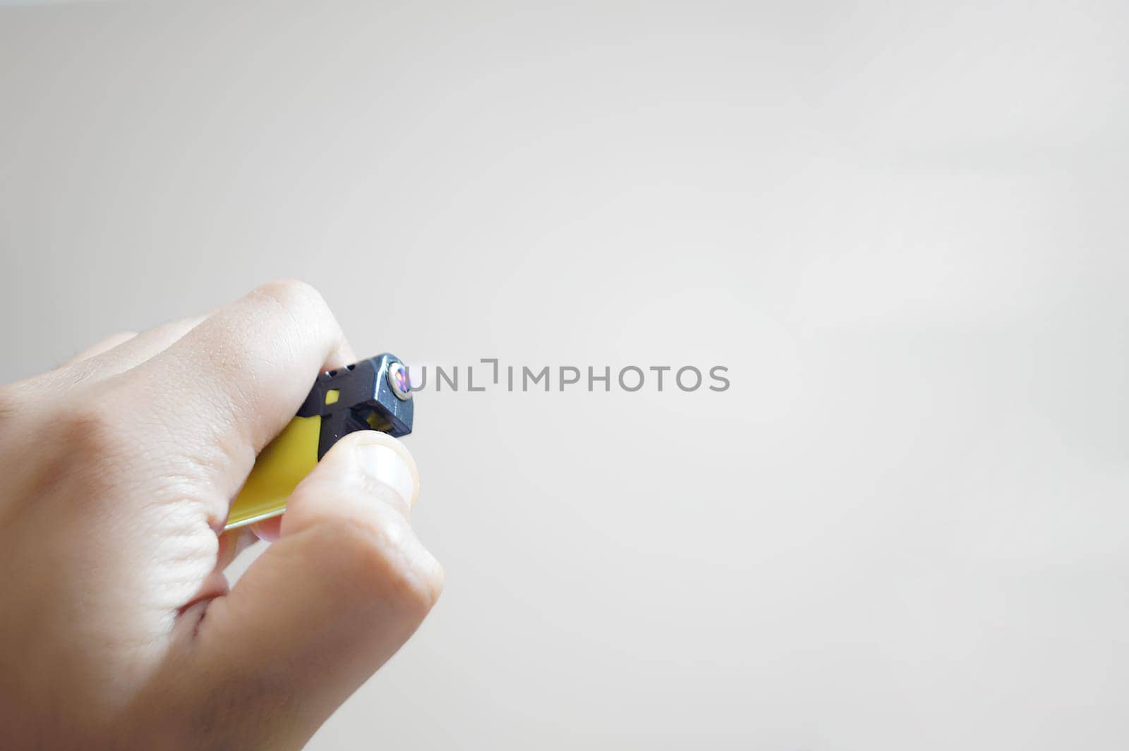 A person is holding a lighter in their hand. High quality photo