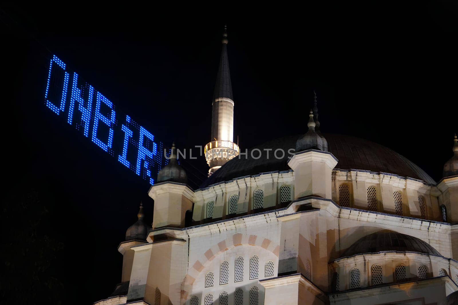 A large big mosque with a blue sign. High quality photo