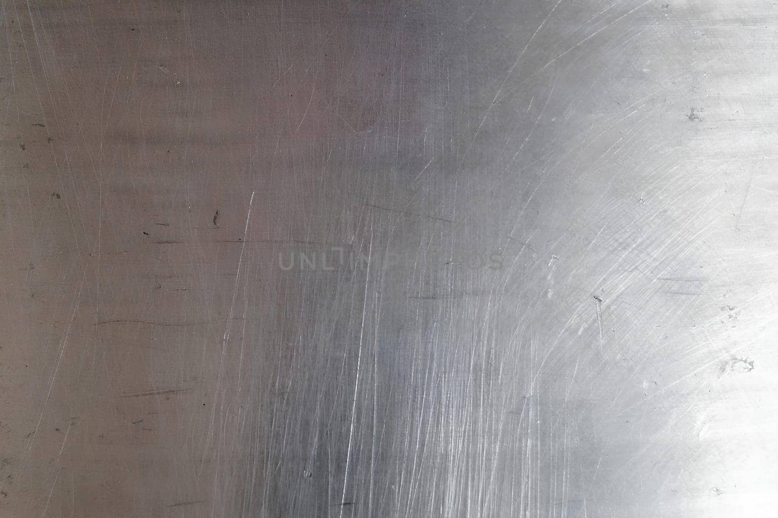 A silver surface with a lot of scratches and marks. High quality photo