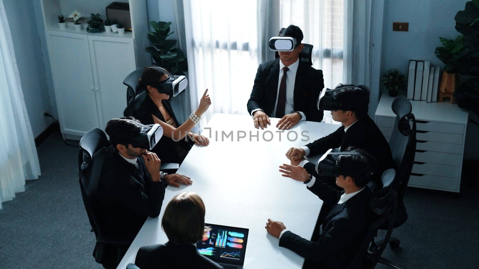 Top view of project manager working on laptop and sending data analysis to business people by using VR glass headset. Professional marketing team enter metadata or virtual world program. Directorate.