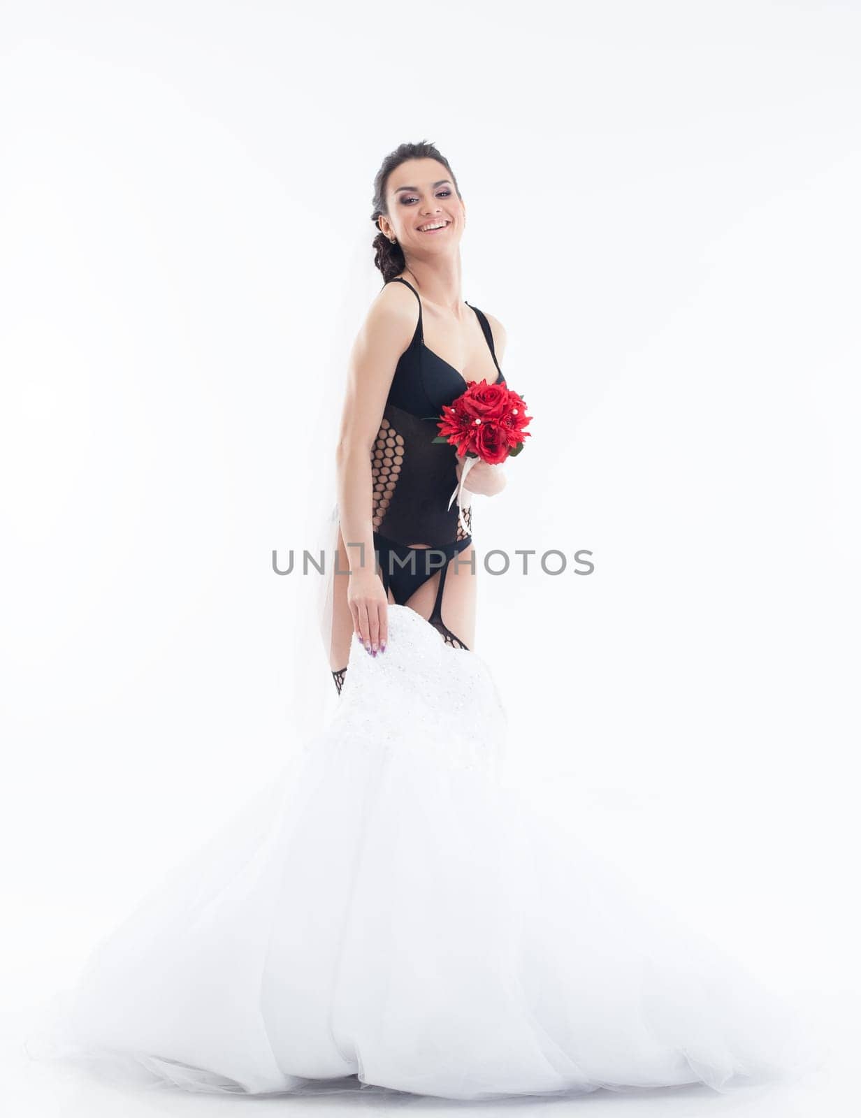 Young cheerful bride posing in erotic lingerie, isolated on white
