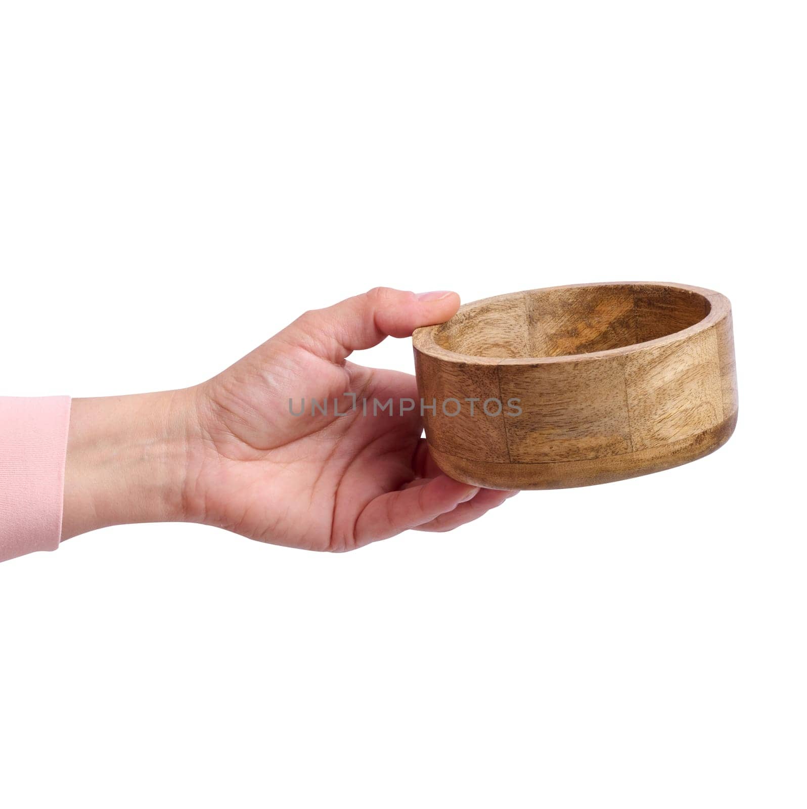 Hand holds an empty brown wooden plate on a white isolated background