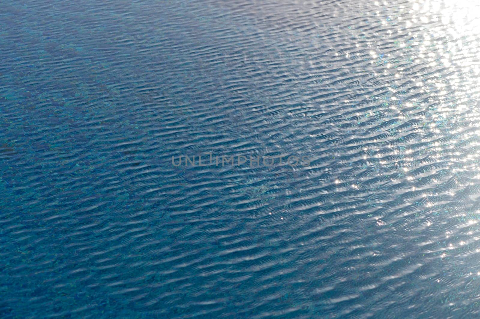Ripple Water in swimming pool with sun reflection 10