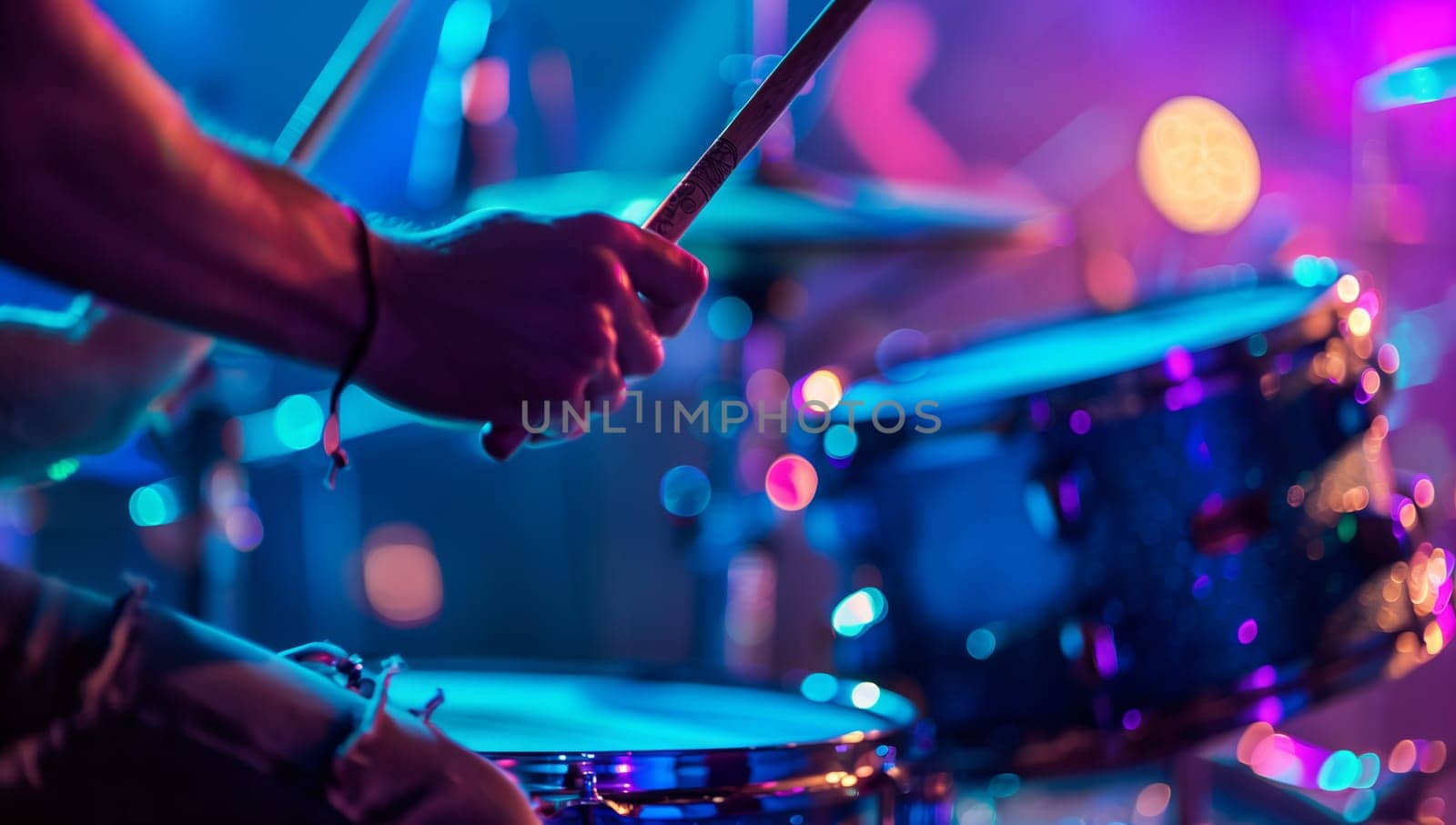 A musician playing a purple drum set with cymbals and drumheads on stage, showcasing their talent on the membranophone musical instrument at a concert