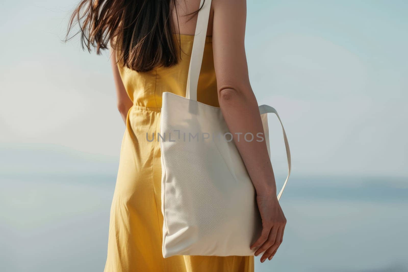 Close up of woman with tote bag mockup on white studio background.