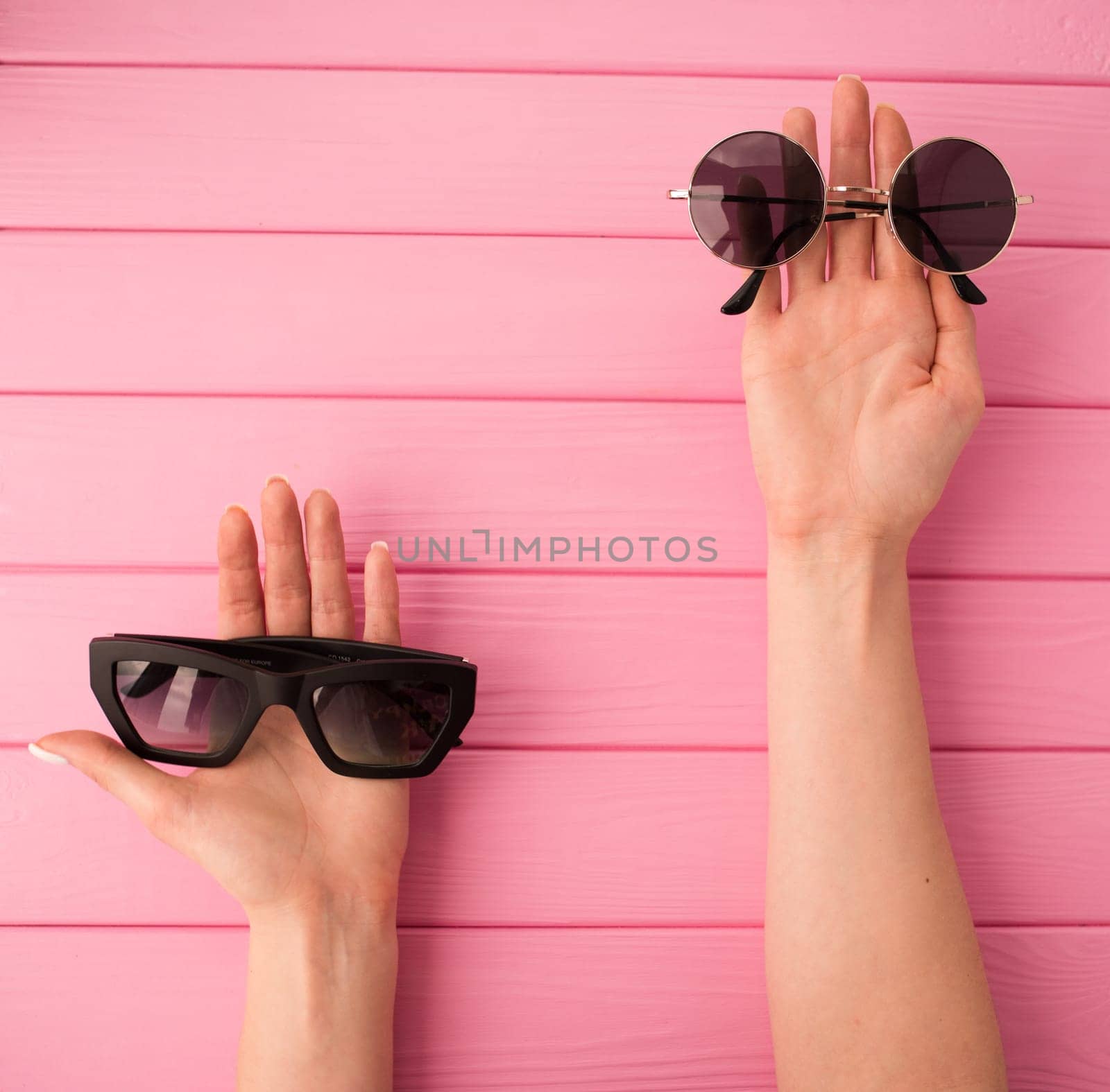 Summer abstract background mockup template woman hands hold Couple sunglasses fashionable by AndriiDrachuk