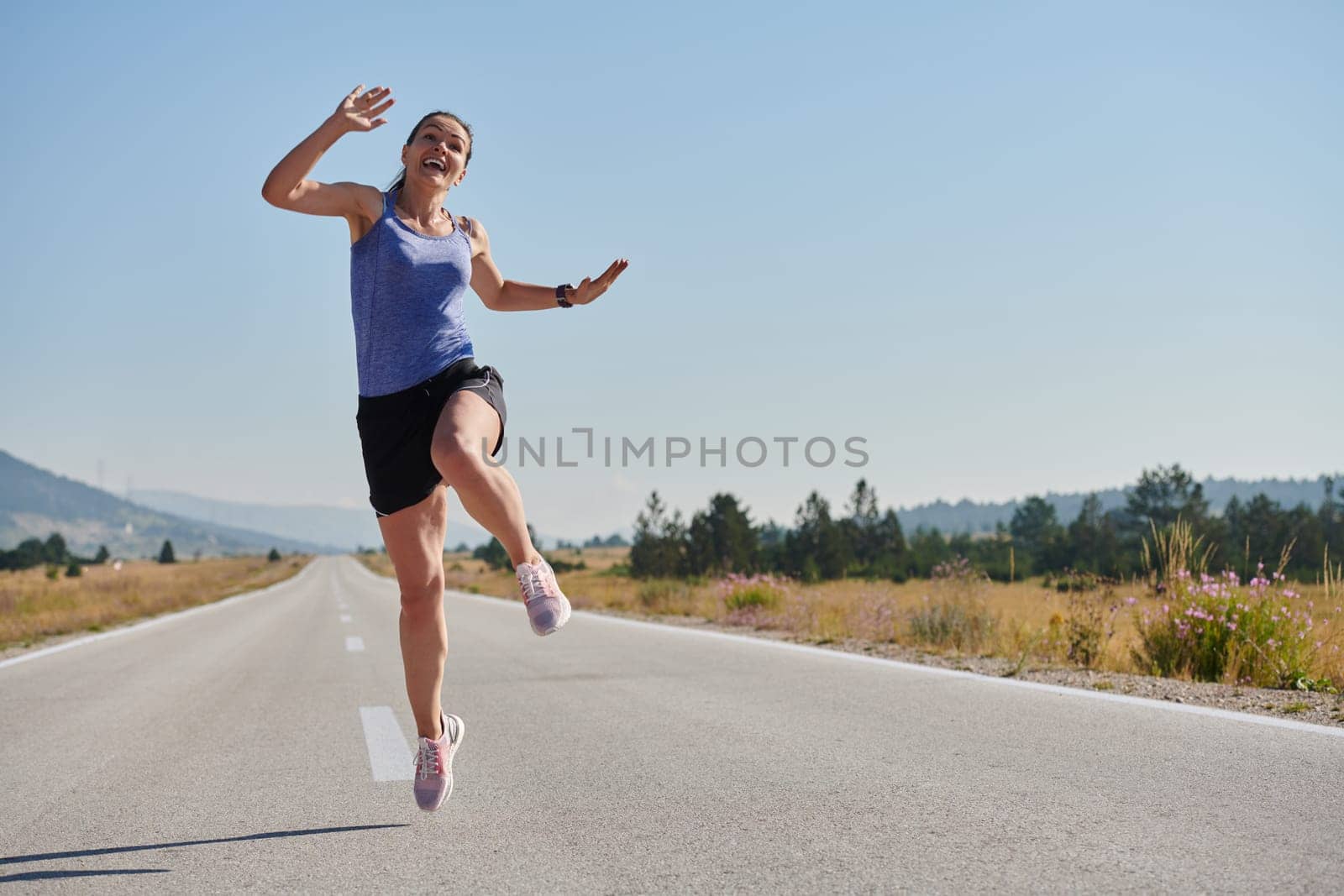 Leap of Victory: Athlete Symbolizes Success and Dedication Through Mid-Air Jump. by dotshock