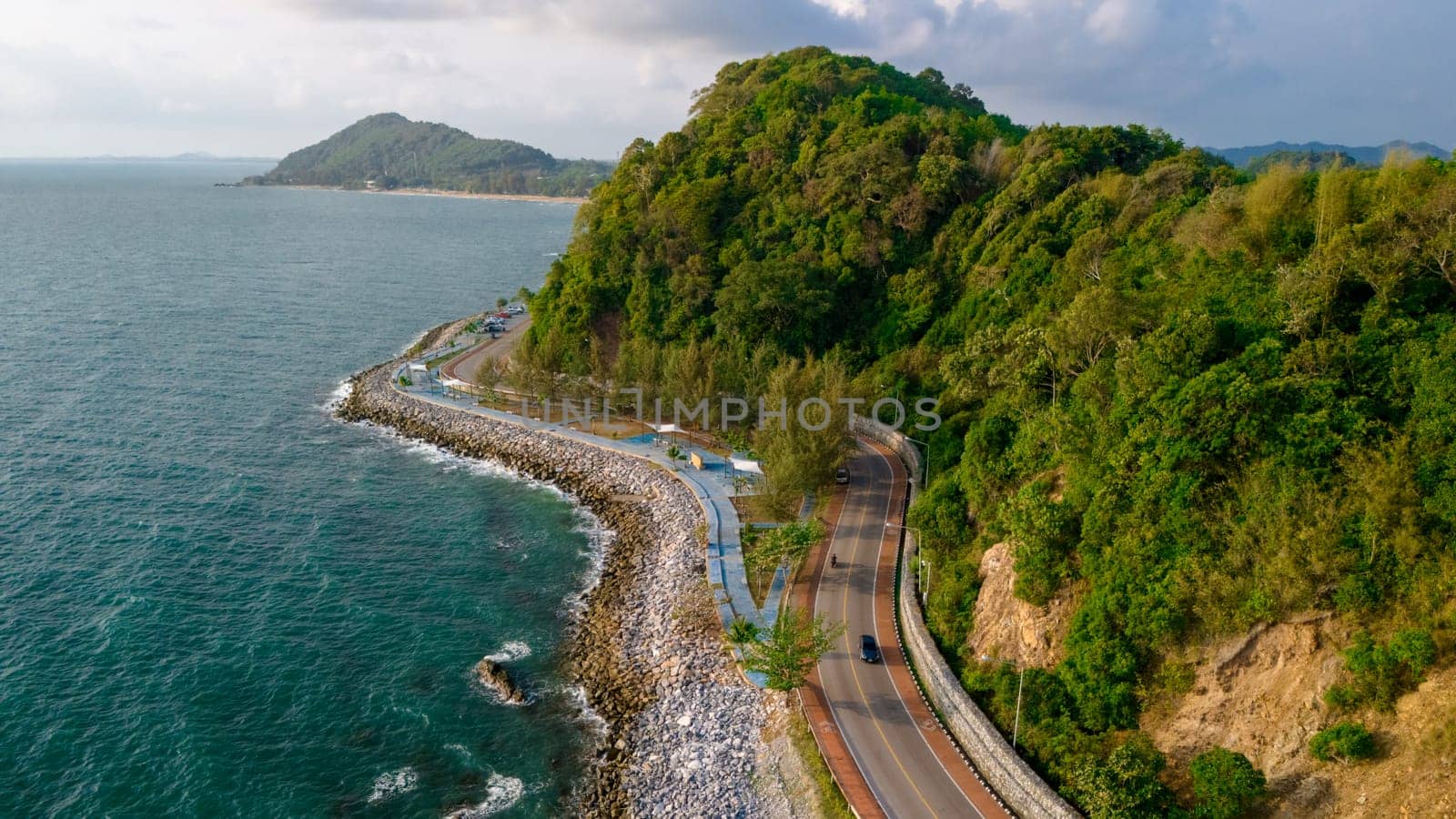 car driving on the curved road of Thailand. road landscape in summer. it's nice to drive on the beachside highway. Chantaburi Province Thailand, at sunset in the mountains