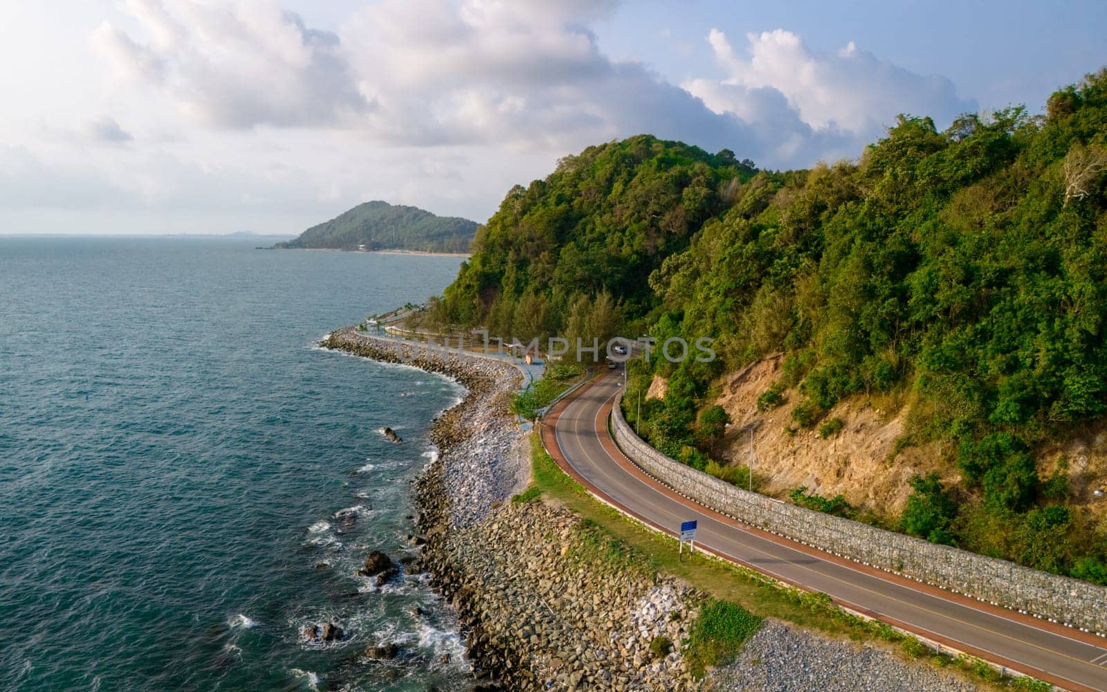 car driving on the curved road of Thailand. road landscape in summer. it's nice to drive on the beachside highway. Chantaburi Province Thailand, summer road trip