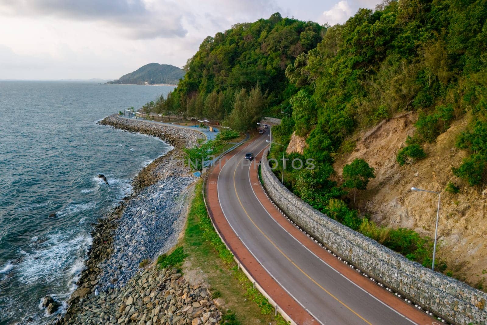 car driving on the curved road of Thailand. road landscape in summer. it's nice to drive on the beachside highway. Chantaburi Province Thailand, road trip by the ocean in summer