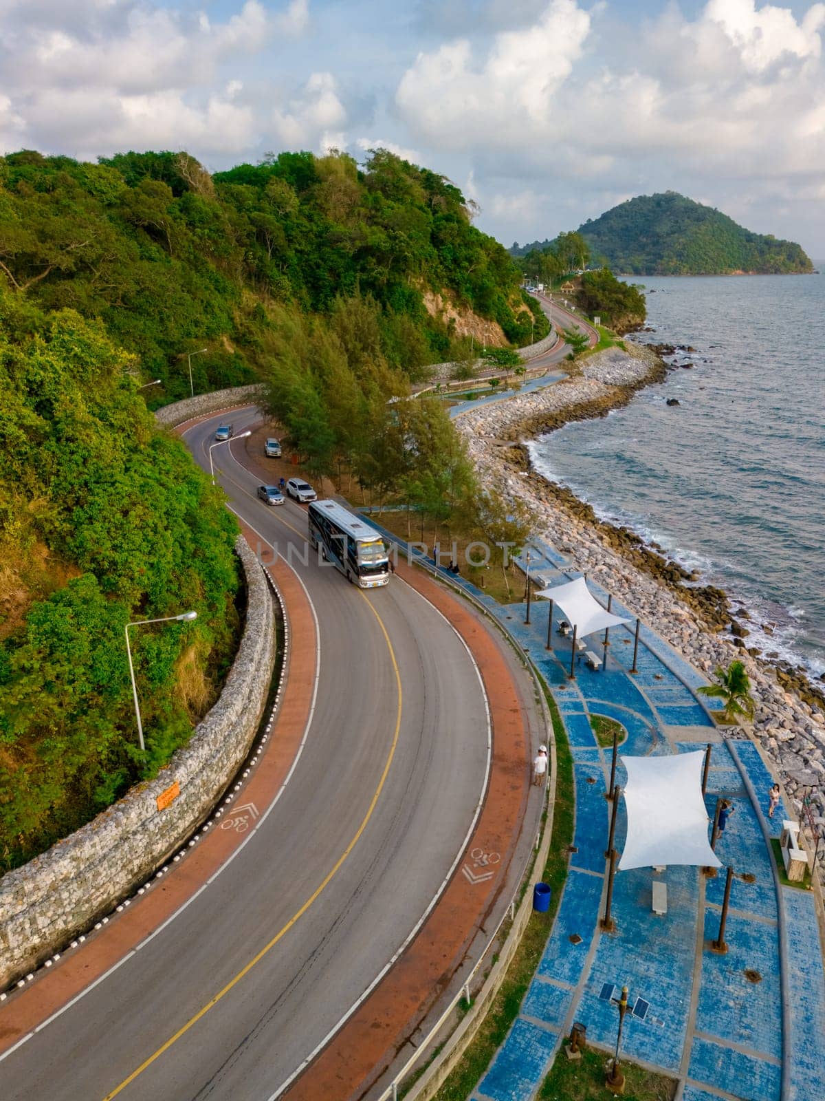 car driving on the curved road of Thailand. road landscape in summer. it's nice to drive on the beachside highway. Chantaburi Province Thailand, road trip in Thailand