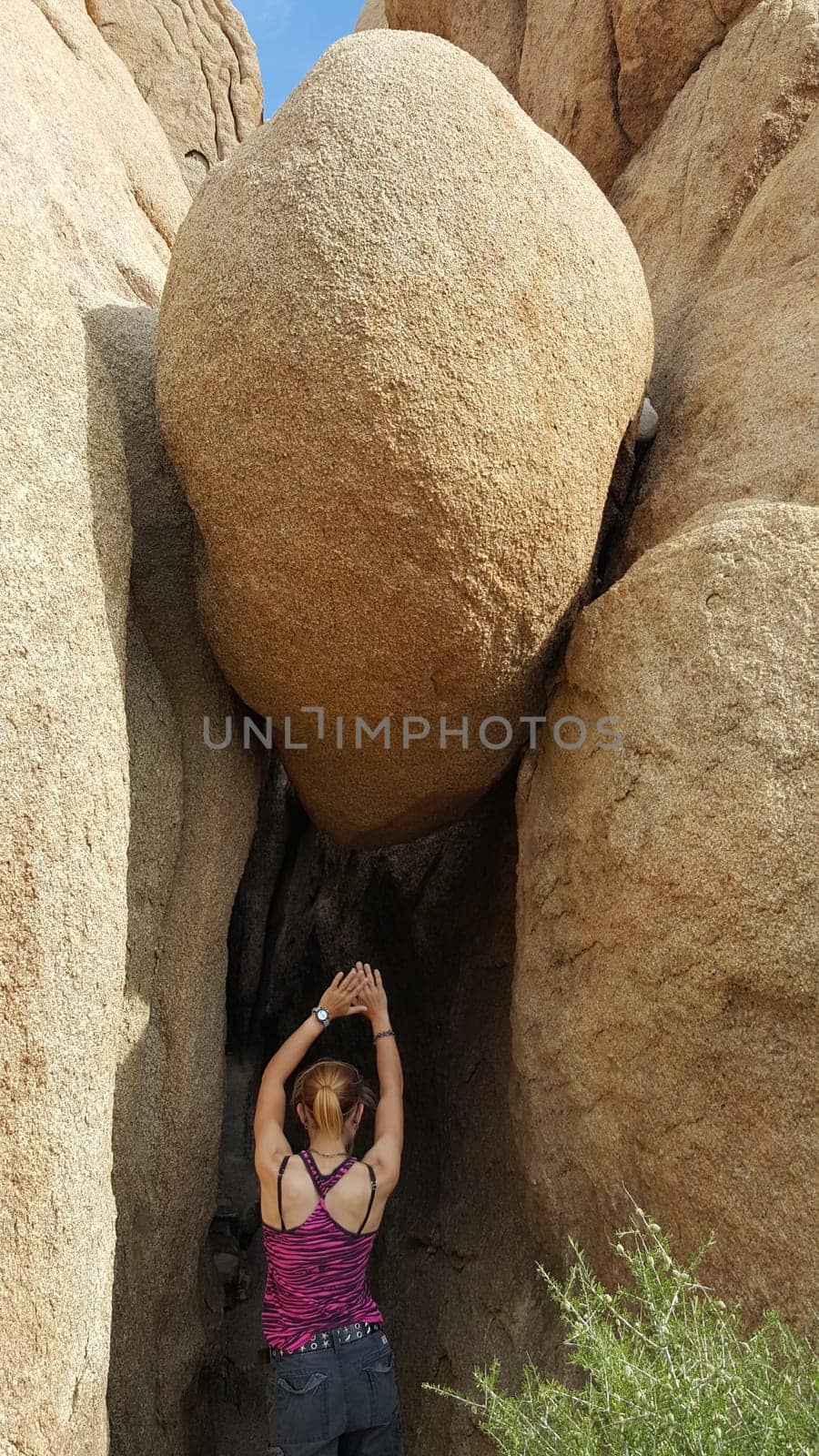 Fit Woman Stretching while Hiking in Joshua Tree National Park, California . High quality photo