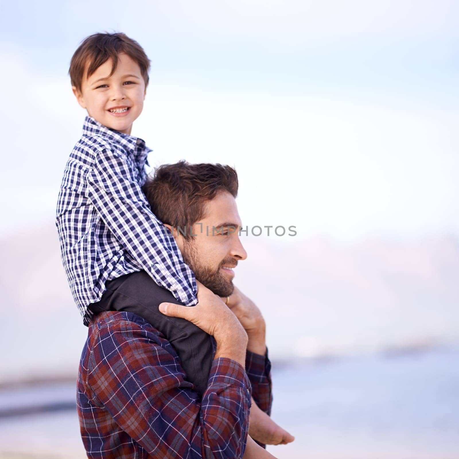 Ocean, portrait and dad with child on shoulders, smile and mockup space on outdoor adventure. Support, face of father and son in nature for fun, bonding and happy trust on beach holiday together.