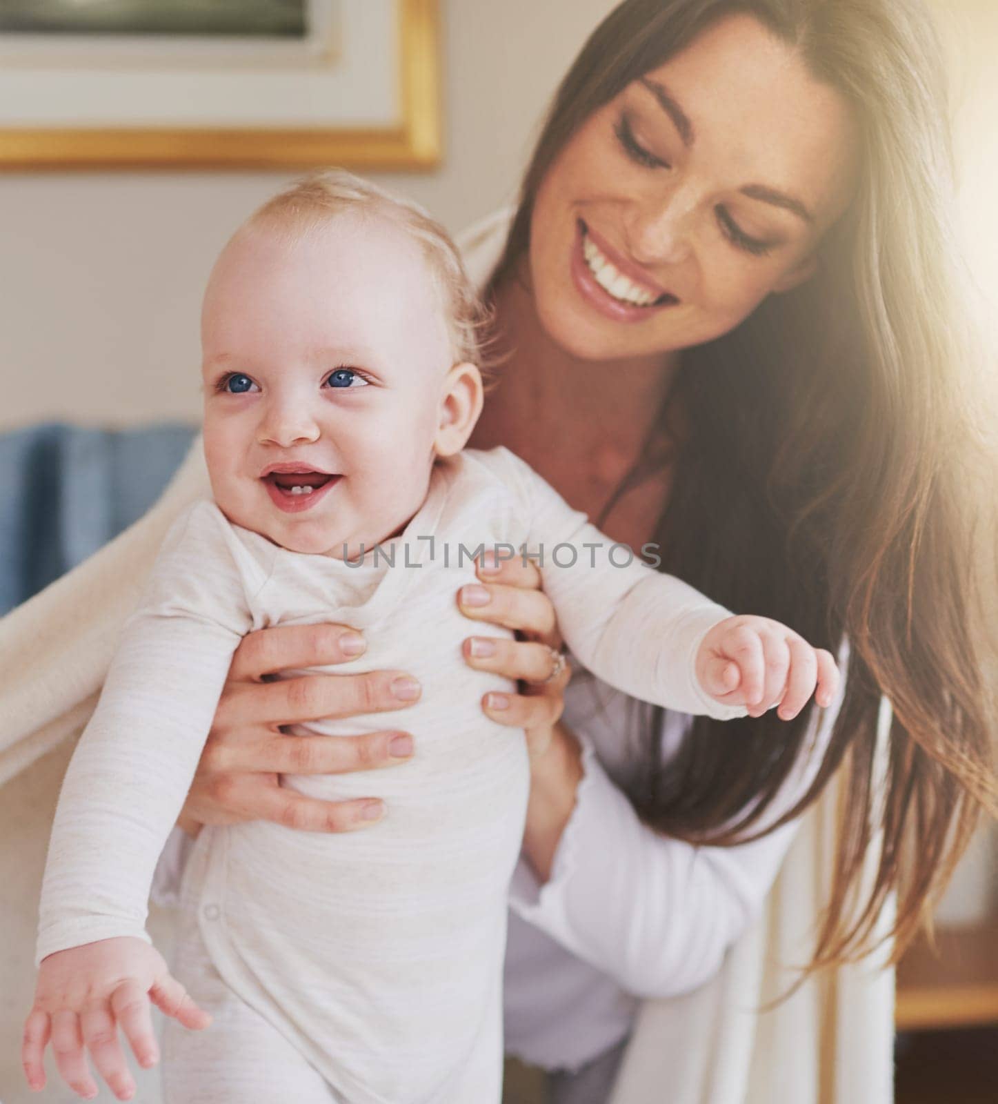 Family, home and mother playing with baby for bonding, relationship and care for motherhood. Love, parenting and happy mom with newborn infant for child development, support and affection in house.