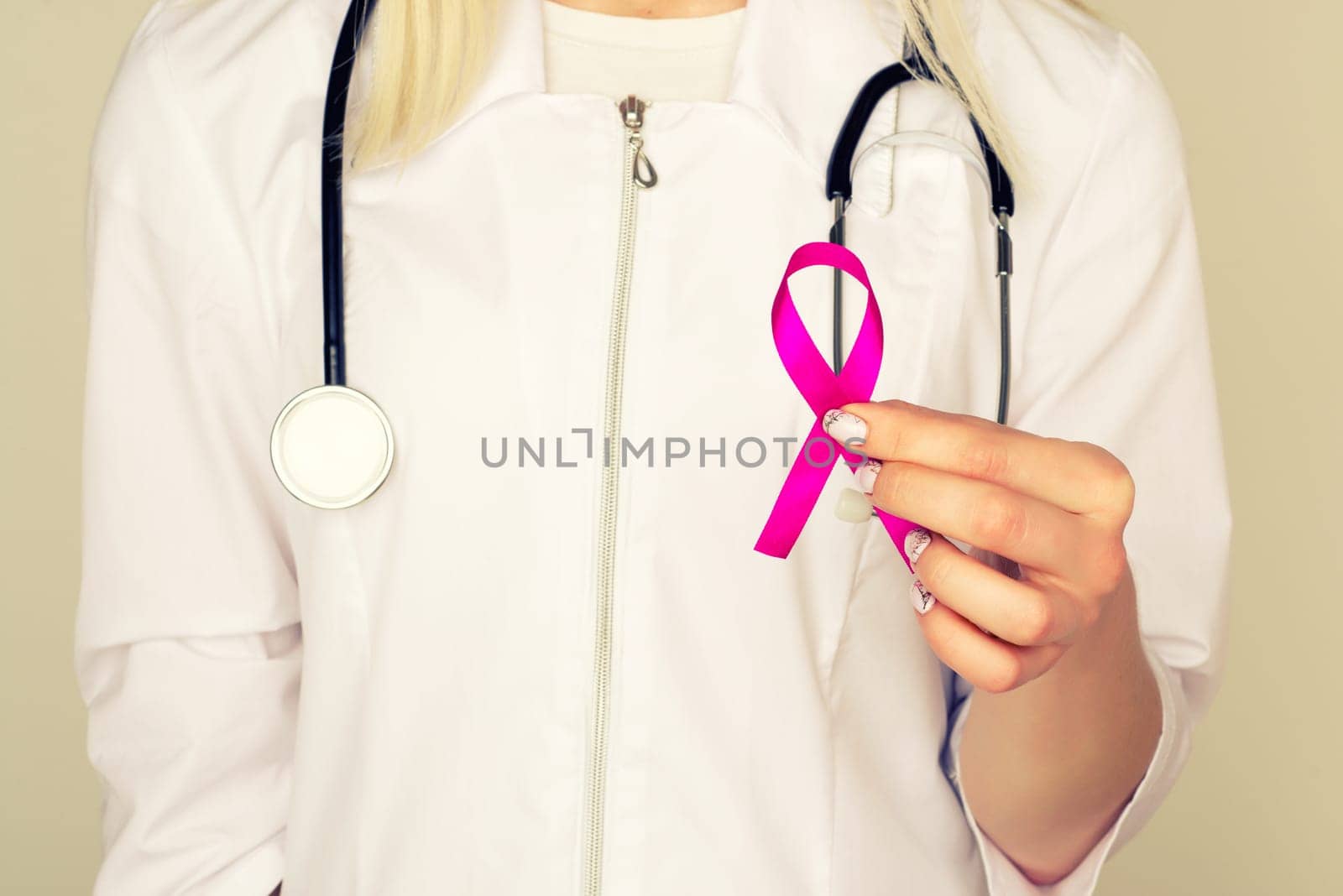 Female Doctor Holds Pink Ribbon, International Breast Cancer Day October 7 - Image