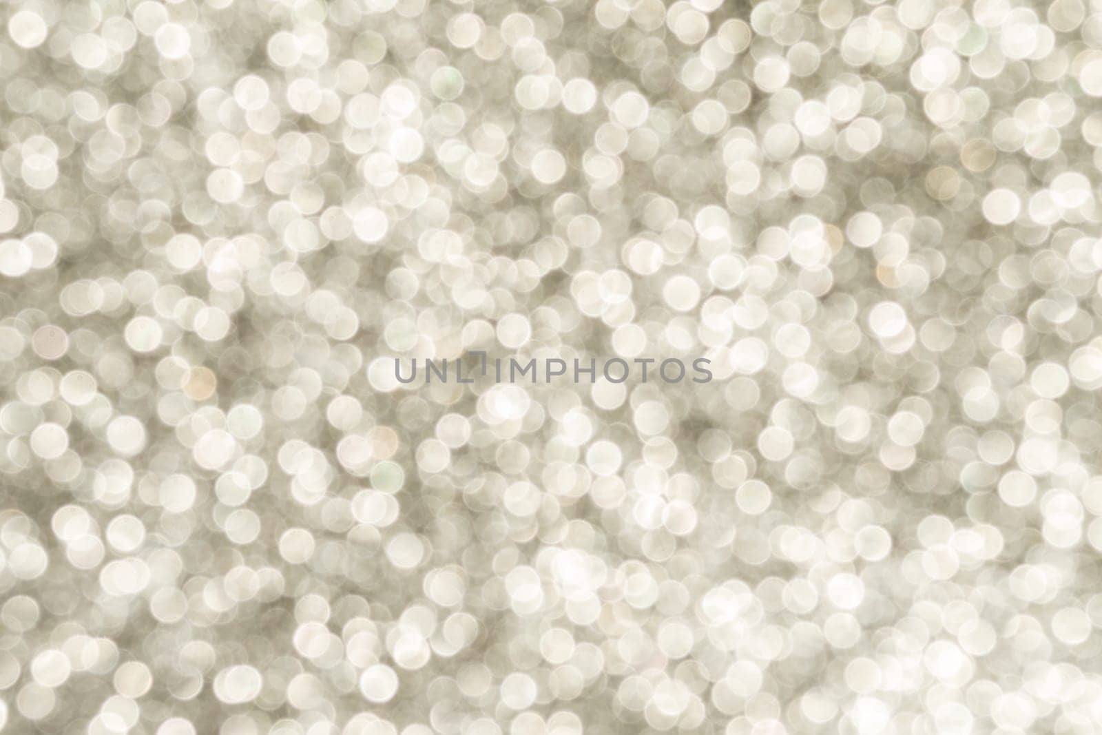 Silver Sparkling Lights Festive background with texture. Abstract Christmas twinkled bright bokeh defocused and Falling stars. Winter Card or invitation