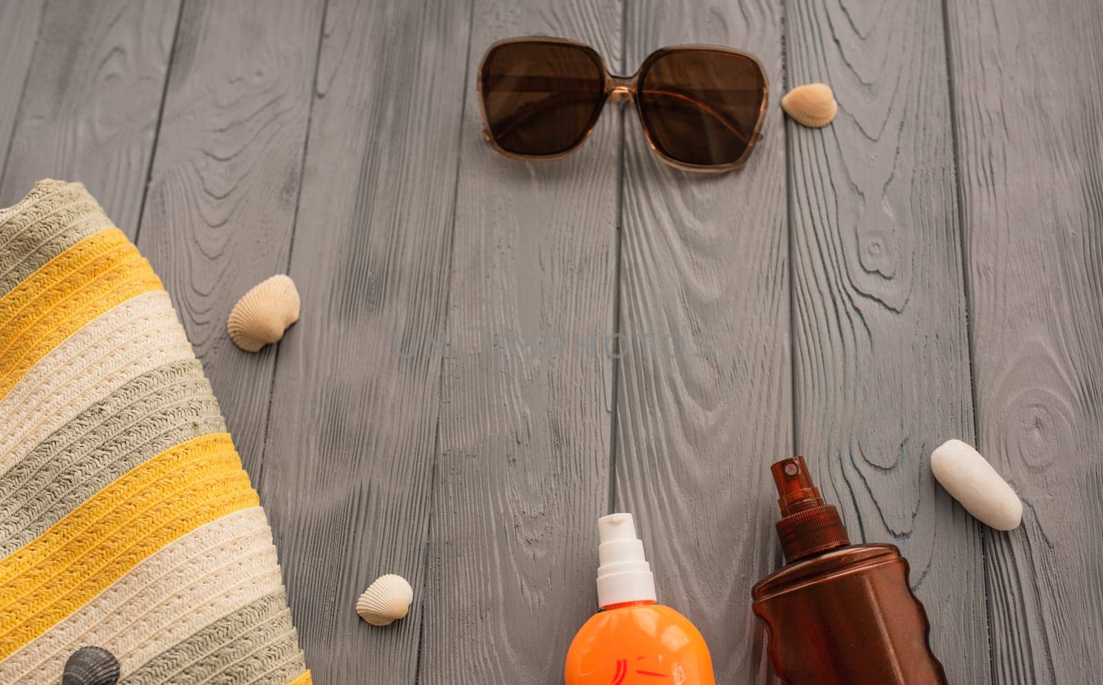 beachwear bag sun protection sunglasses sunscreen spray lotion cream care tan ultra-violet rays. Summer background template mockup free space pattern composition text. Top view above wooden background