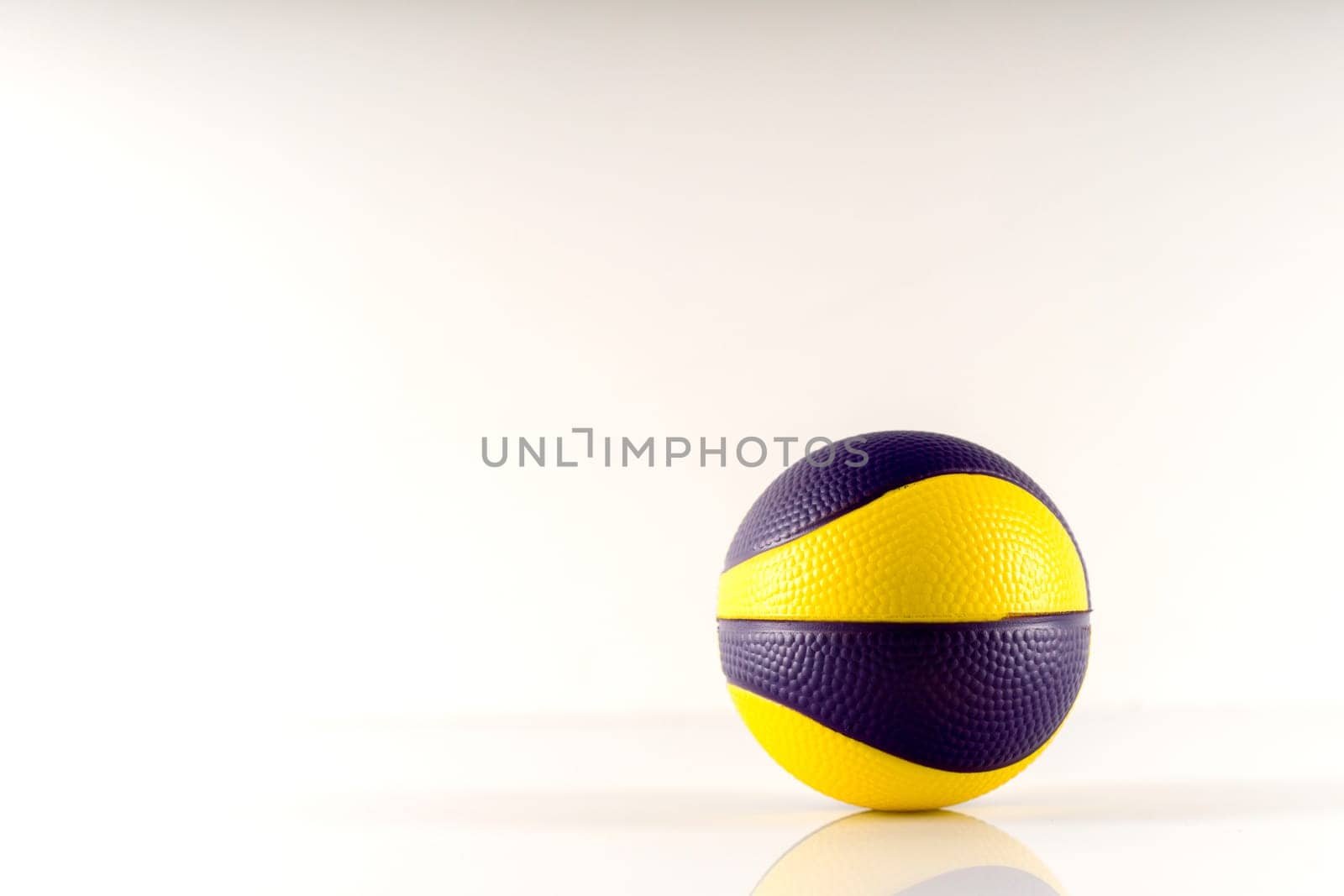 Basketball ball with yellow and purple spots on a white background. Antistress ball