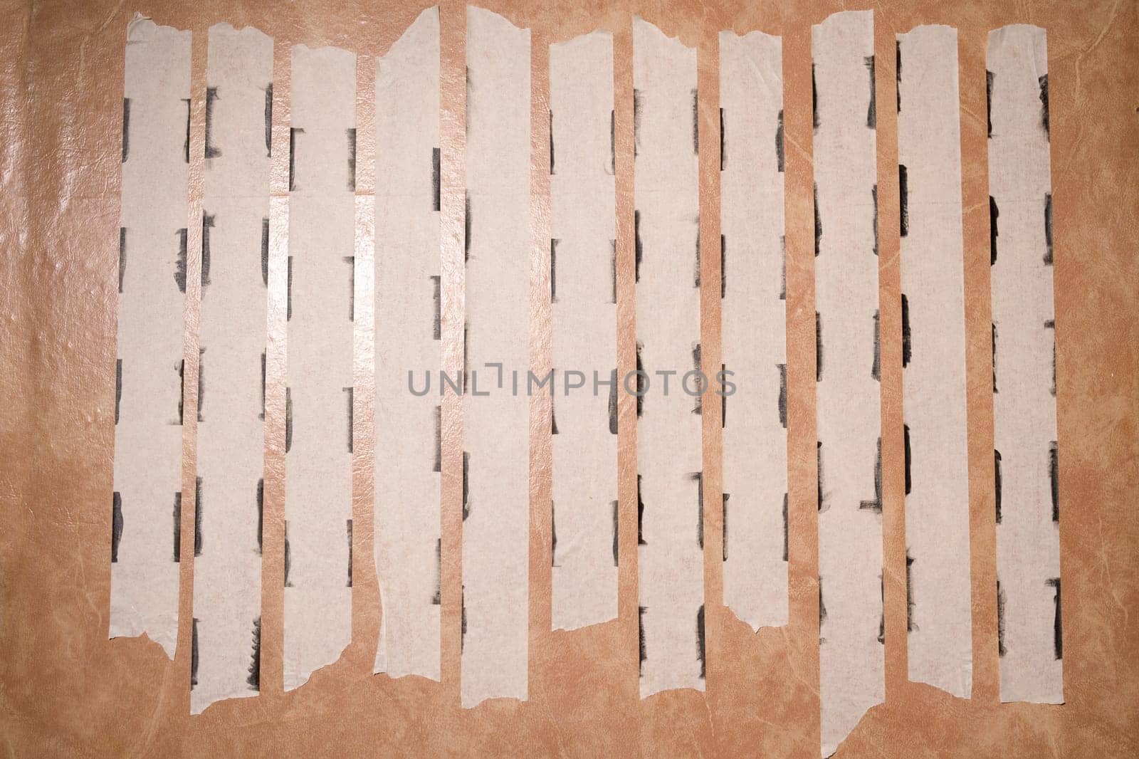 Strips of uses of masking tape along the edges of the paint.