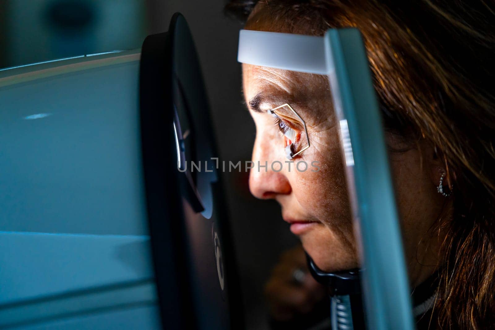 Woman with eye opener during a laser treatment for glaucoma by Huizi