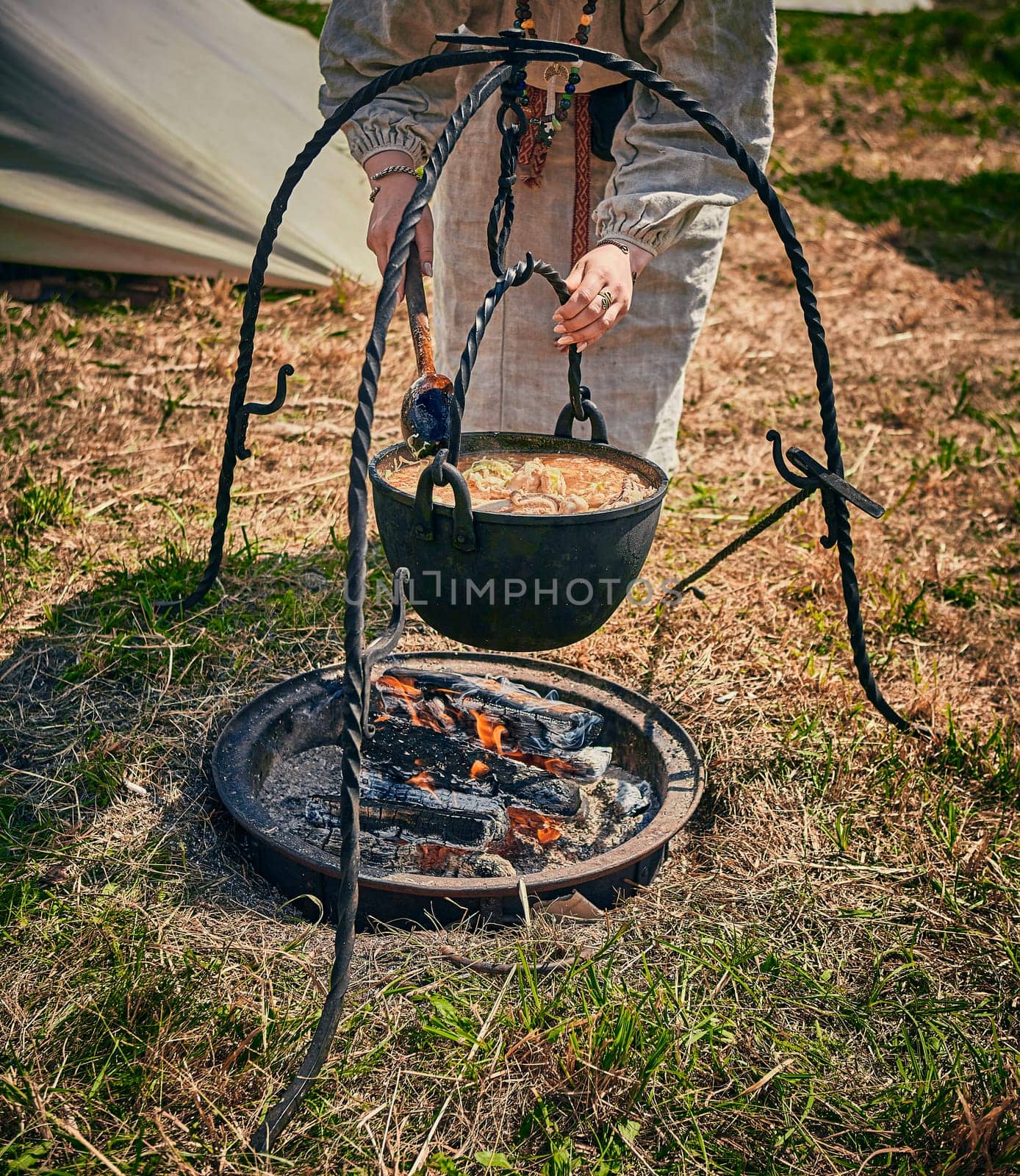 Camping. Soup in a pot over a fire. by Hil