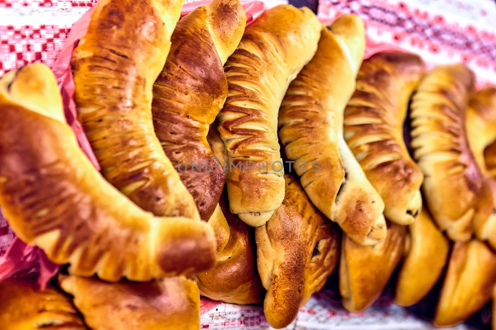 Assorted freshly baked bread and rolls on a white table. Golden brown, crusty bread and soft, fluffy rolls in various shapes and sizes. Perfect for breakfast, lunch, or dinner.