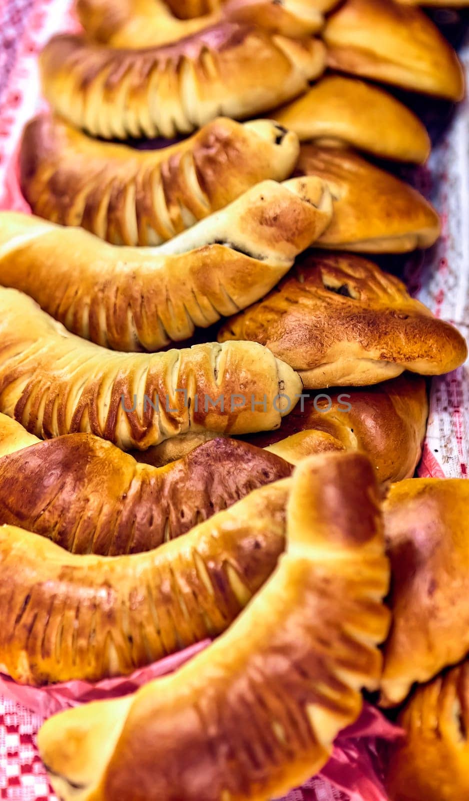 Freshly baked bread and rolls on a table. Isolated on a white background. by Hil