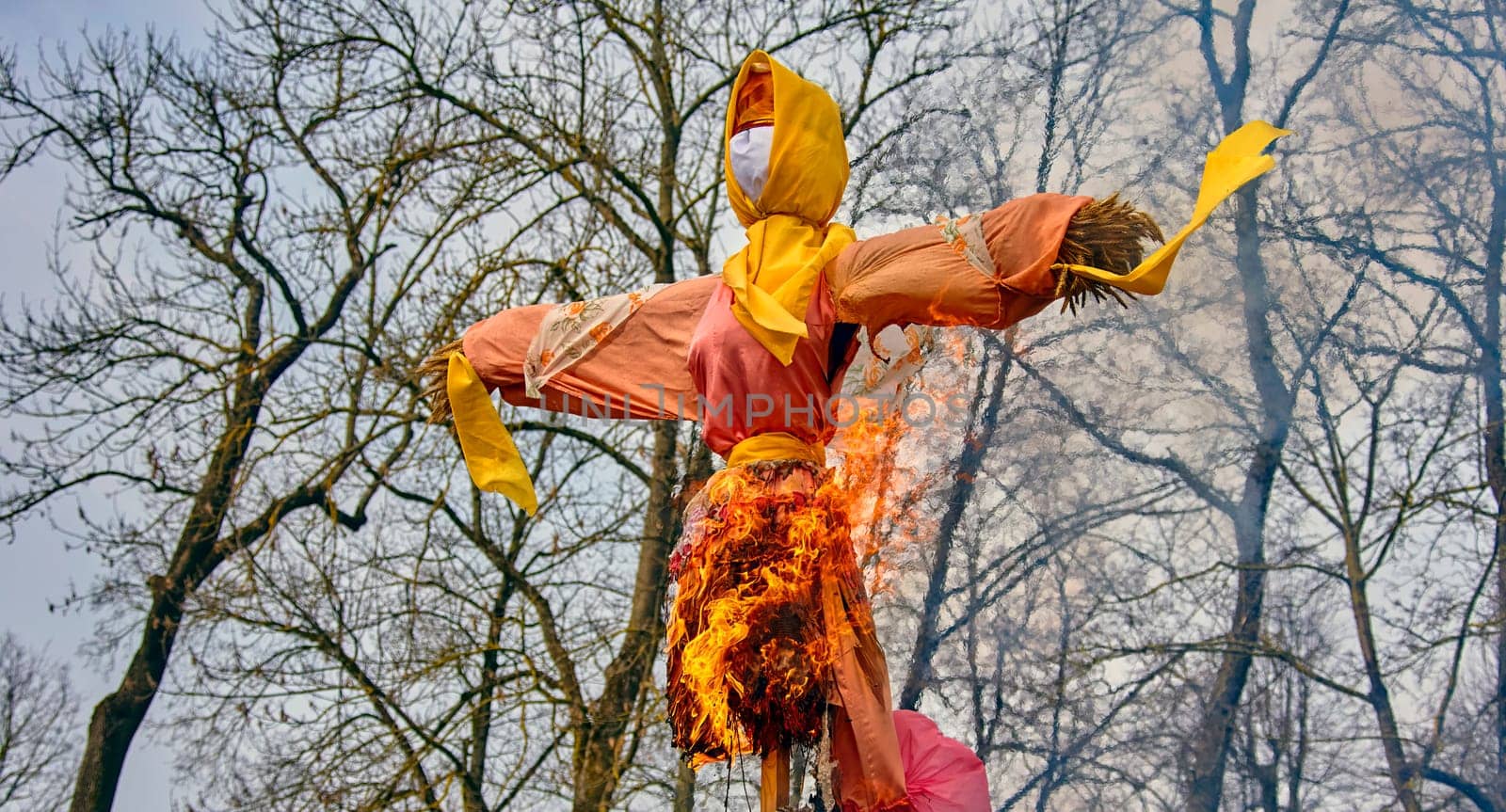 A traditional effigy is set on fire in a rural pasture to celebrate the arrival of spring in the countryside.