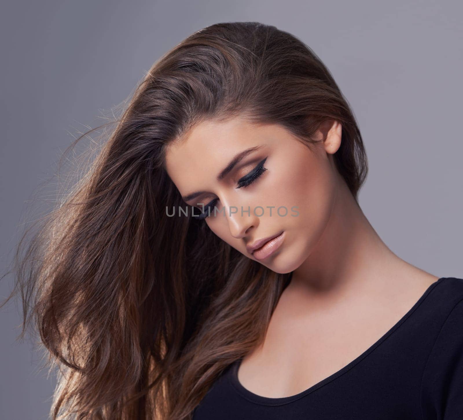 Aesthetic, hair care and woman with beauty, wellness and treatment on a grey studio background. Confidence, person and model with shampoo and keratin with texture and cosmetics with shine and glowing.