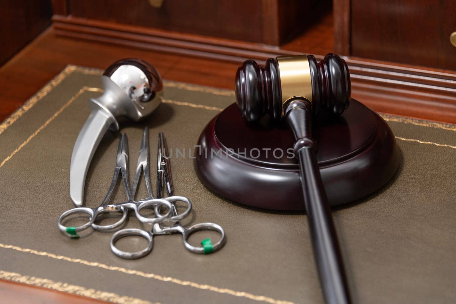 A professional judge's gavel lies next to medical tools, symbolizing legal issues in healthcare