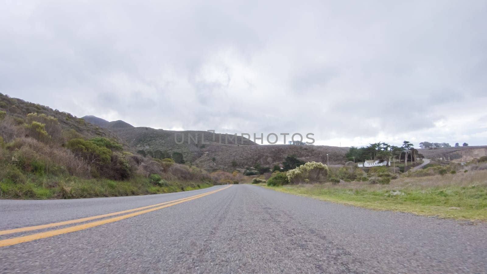 In this serene winter scene, a vehicle carefully makes its way along Los Osos Valley Road and Pecho Valley Road within Montana de Oro State Park.