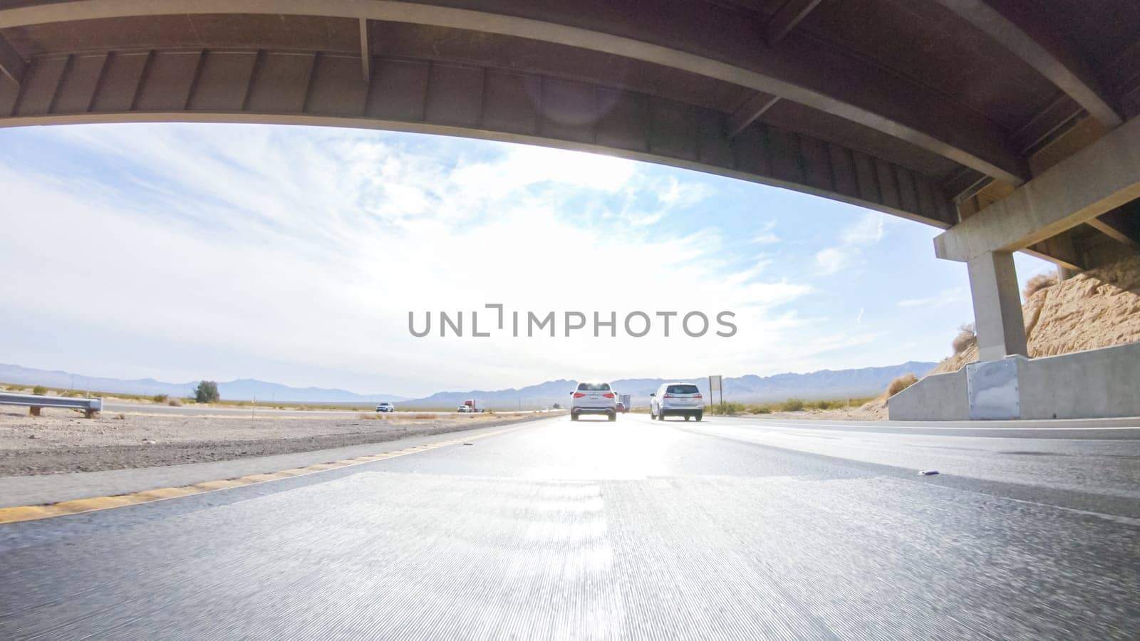 Embarking on a road trip from Nevada to California, driving on Highway 15 during the day offers scenic views and an exciting journey between states.