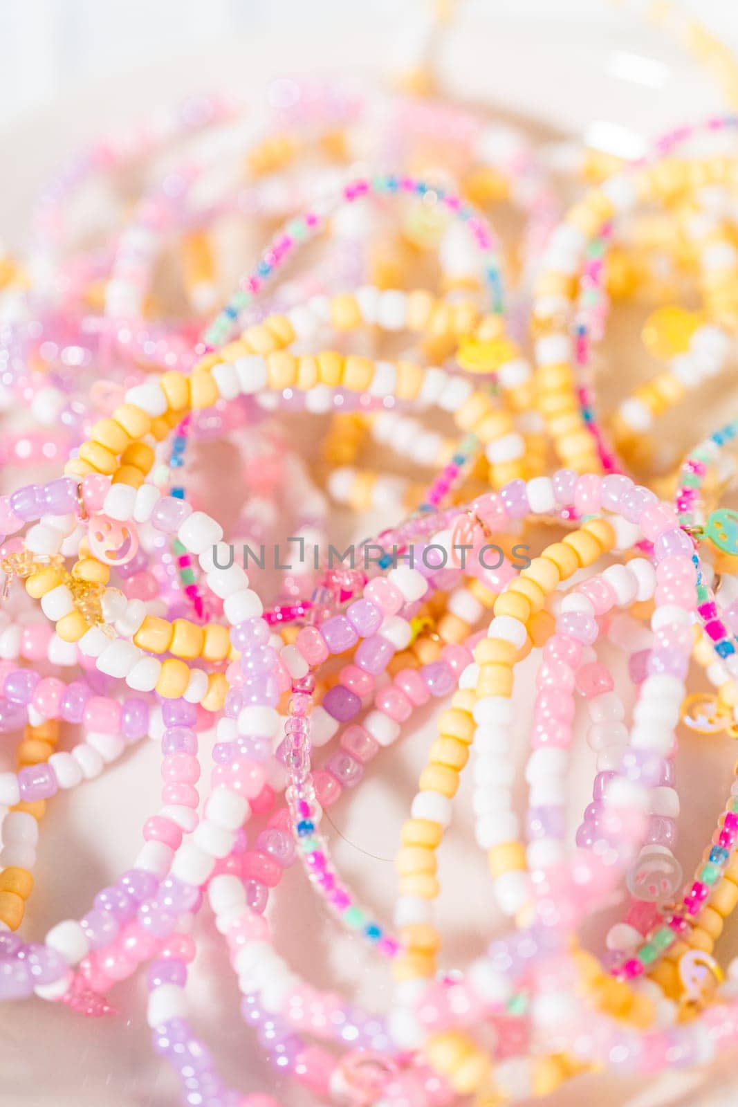 Little girl's charming bracelets adorned with clay and sea beads.