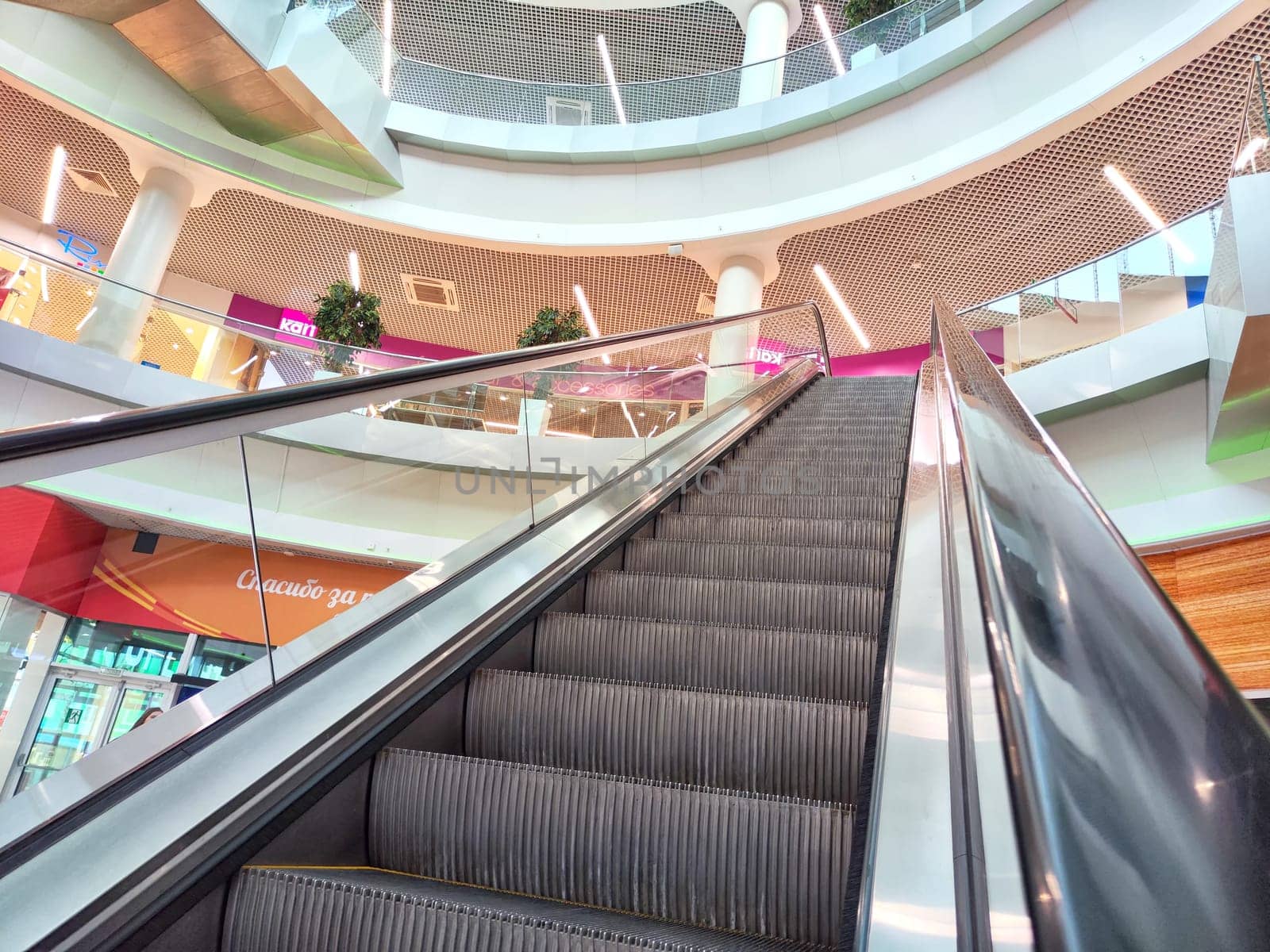 Arkhangelsk, Russia - February 28, 2024: Escalator in a Modern Shopping Mall. Big Escalator inside a vibrant shopping center by keleny