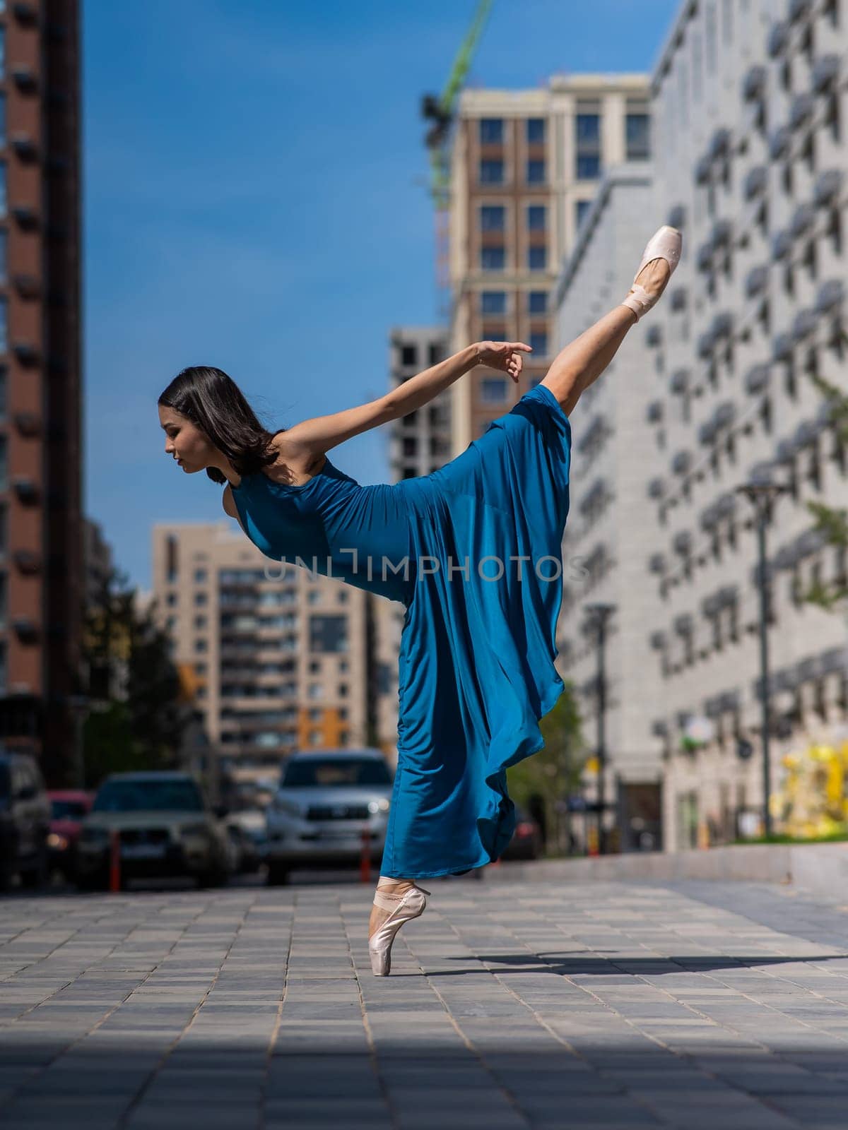 Beautiful Asian ballerina dancing outdoors. Urban landscape. by mrwed54