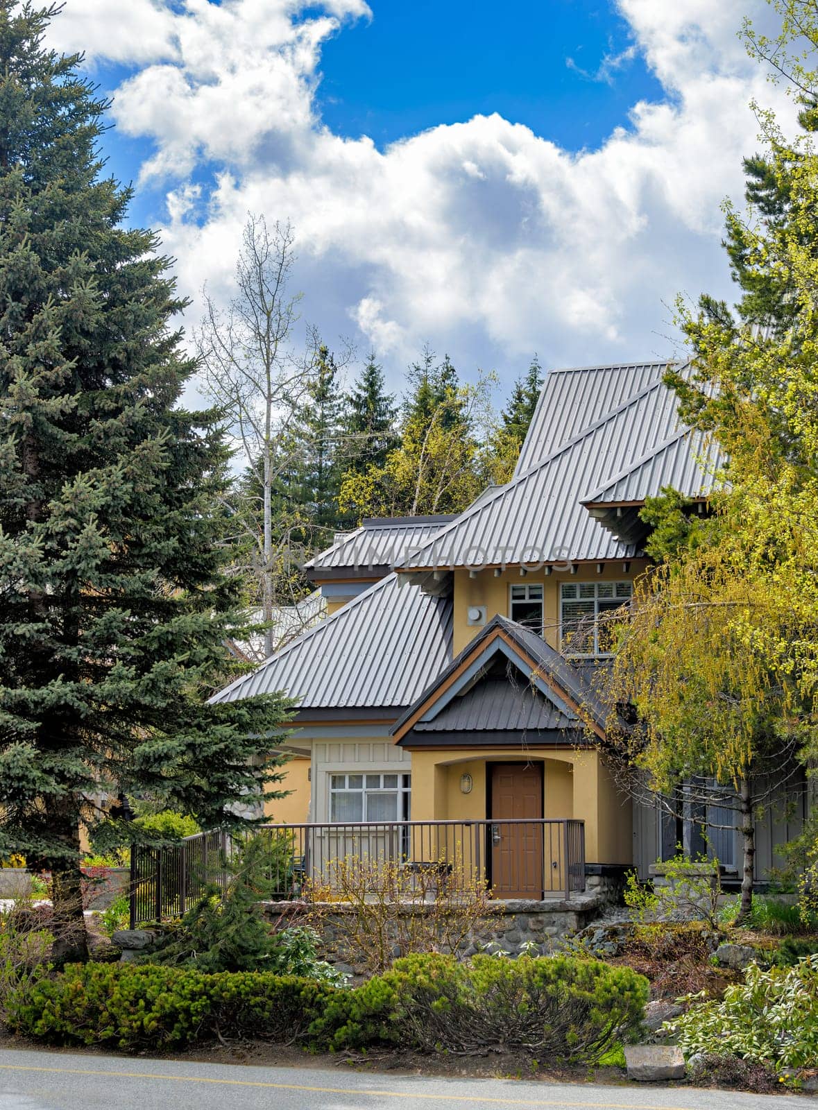 Luxurious residential house with big roof on spring season in Canada by Imagenet