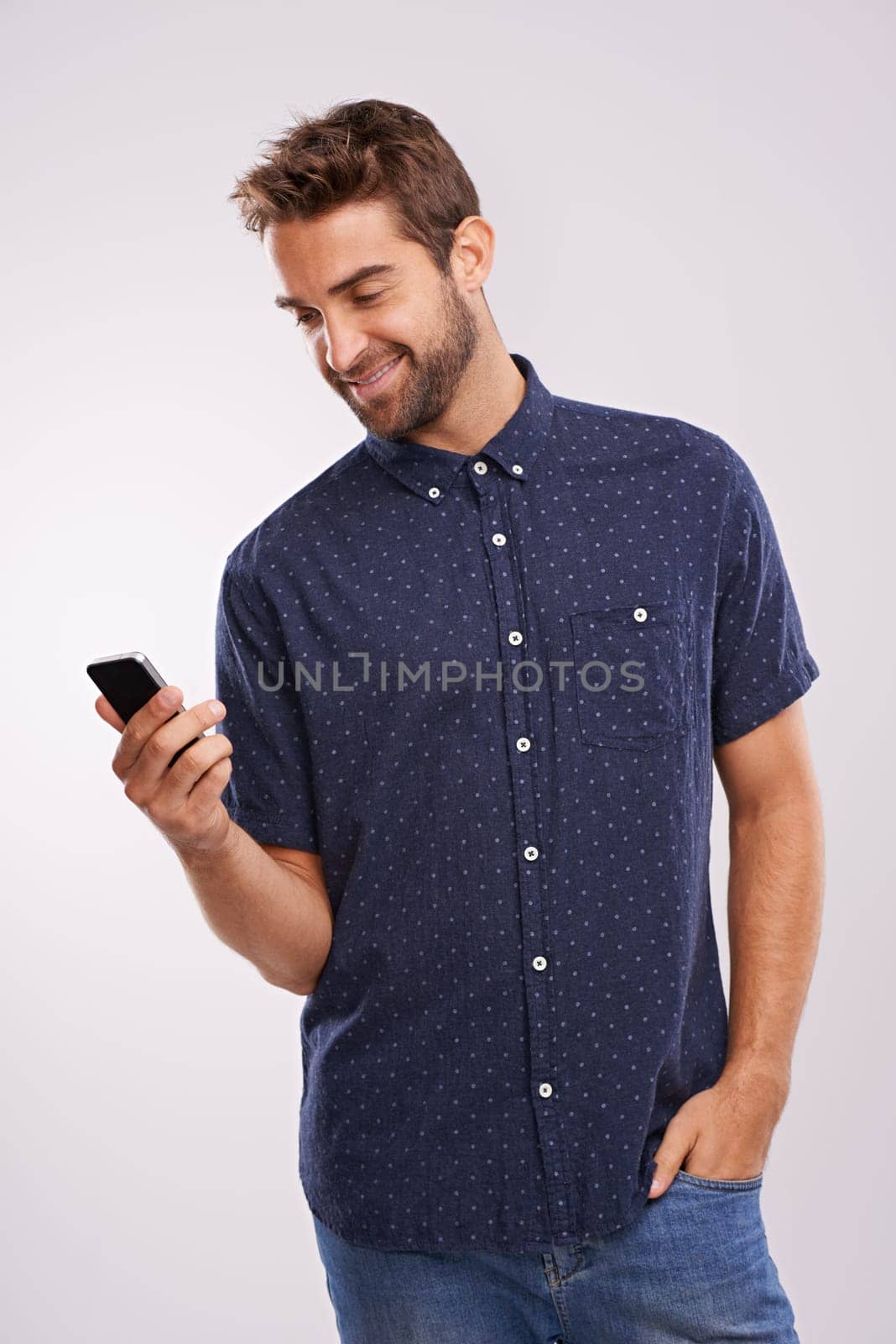 Networking, communication and man with phone in studio background with social media in mockup Happy, businessman and reading email on smartphone with news, information or scroll search on internet.