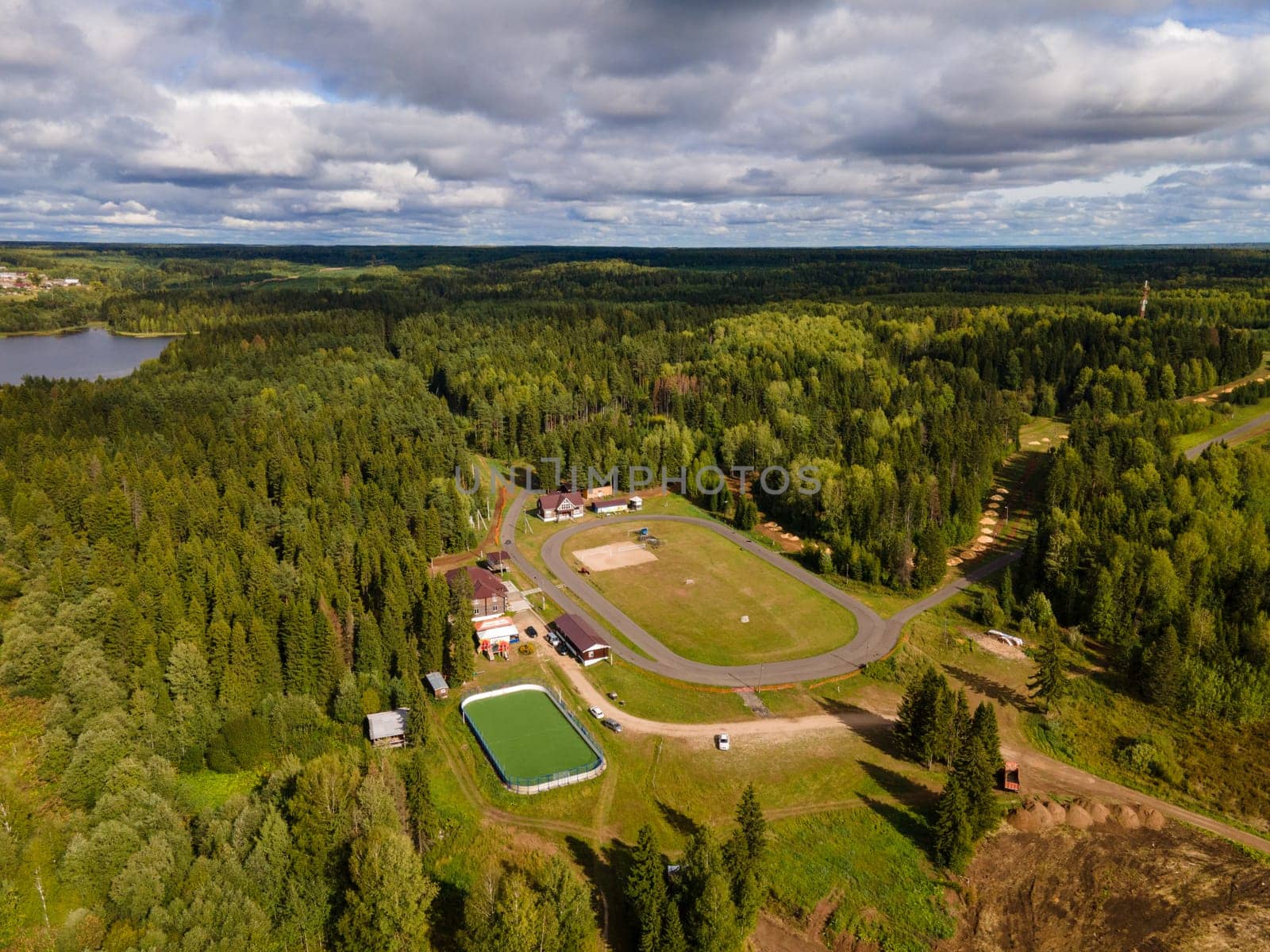 Aerial view of soccer field on river camp under cloudy sky in region of Kirov Russia