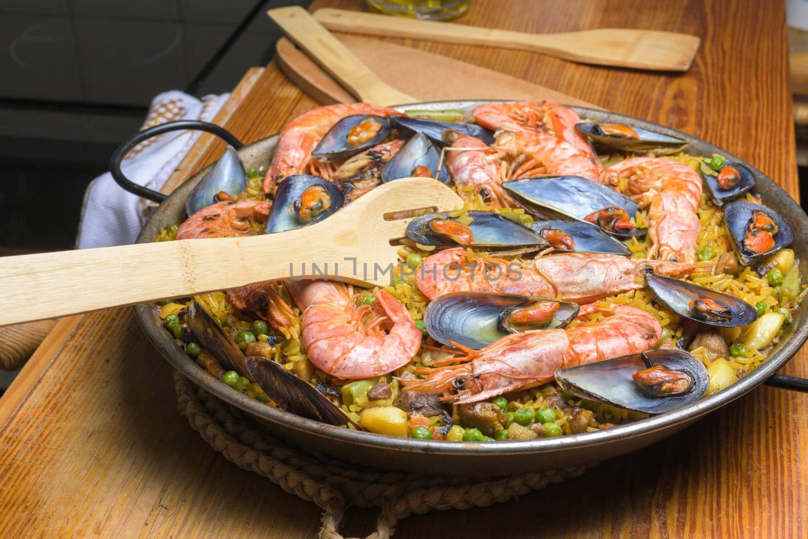 Wooden spoon resting on a pan of hearty shrimp paella, typical Spanish cuisine, typical Spanish cuisine, Majorca, Balearic Islands, Spain by carlosviv