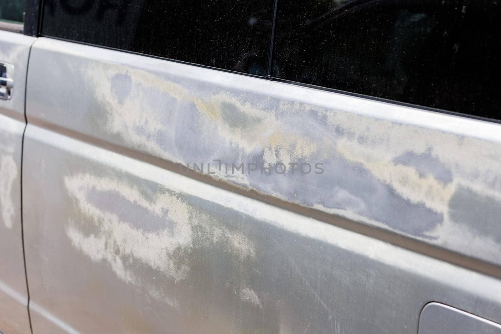 silver car side with big sun burns, coating was burned under constant sun light exposure, closeup by z1b