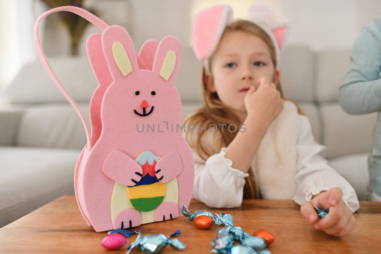 Girl with bunny ears and basket for chocolate eggs Easter by Godi