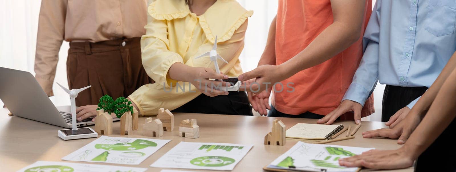 Windmill model placed during presenting green business. Closeup. Delineation. by biancoblue