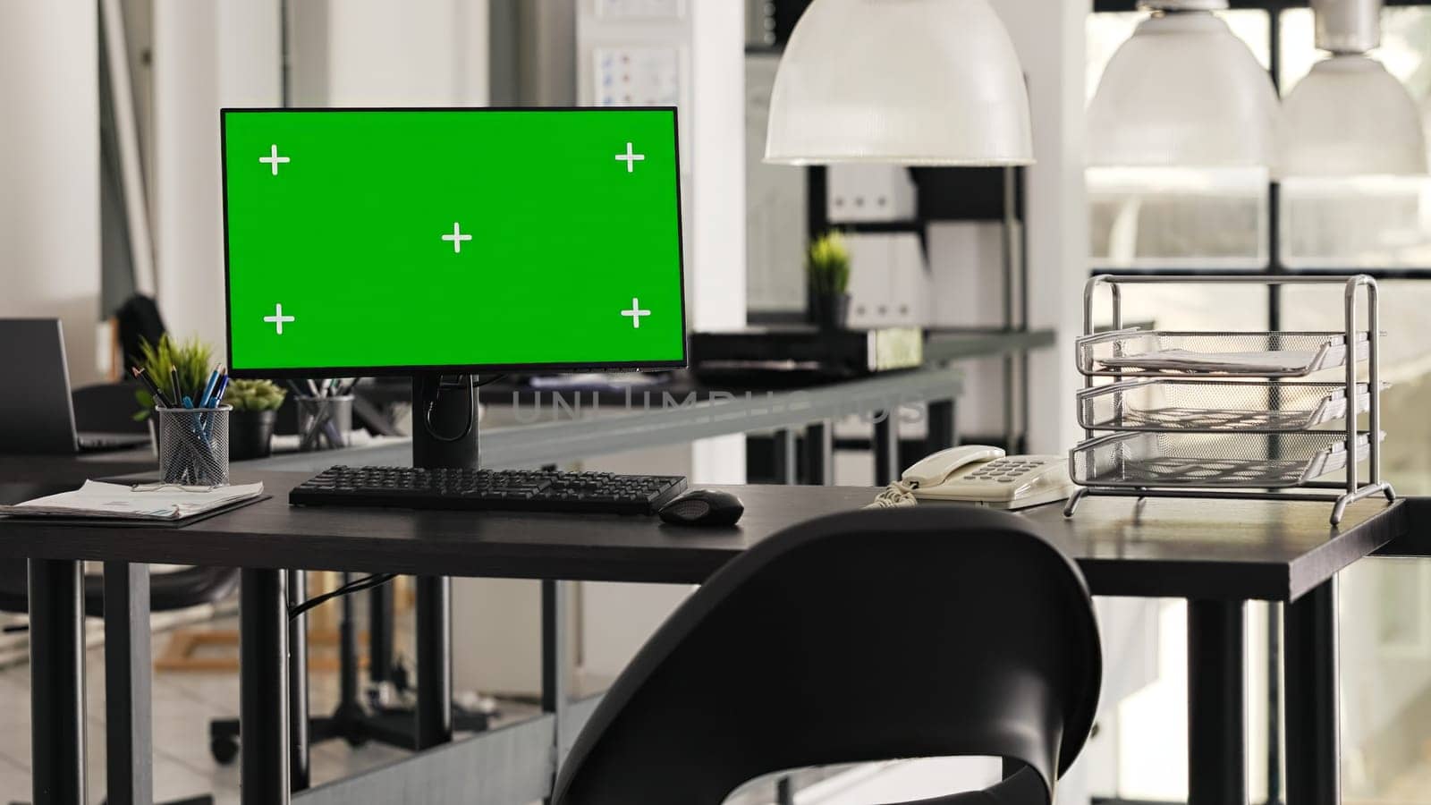 Greenscreen display placed on office desk used for business operations in startup space, empty workstation with monitor running isolated mockup copyspace. Desktop showing blank chromakey display.