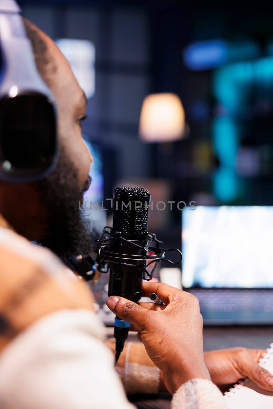 Black person using podcast equipment by DCStudio