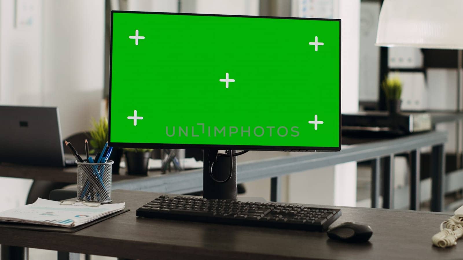 Workstation desk with greenscreen monitor in business agency office, empty coworking space with modern gadgets used for company operations. Computer showing chromakey and mockup template on display.