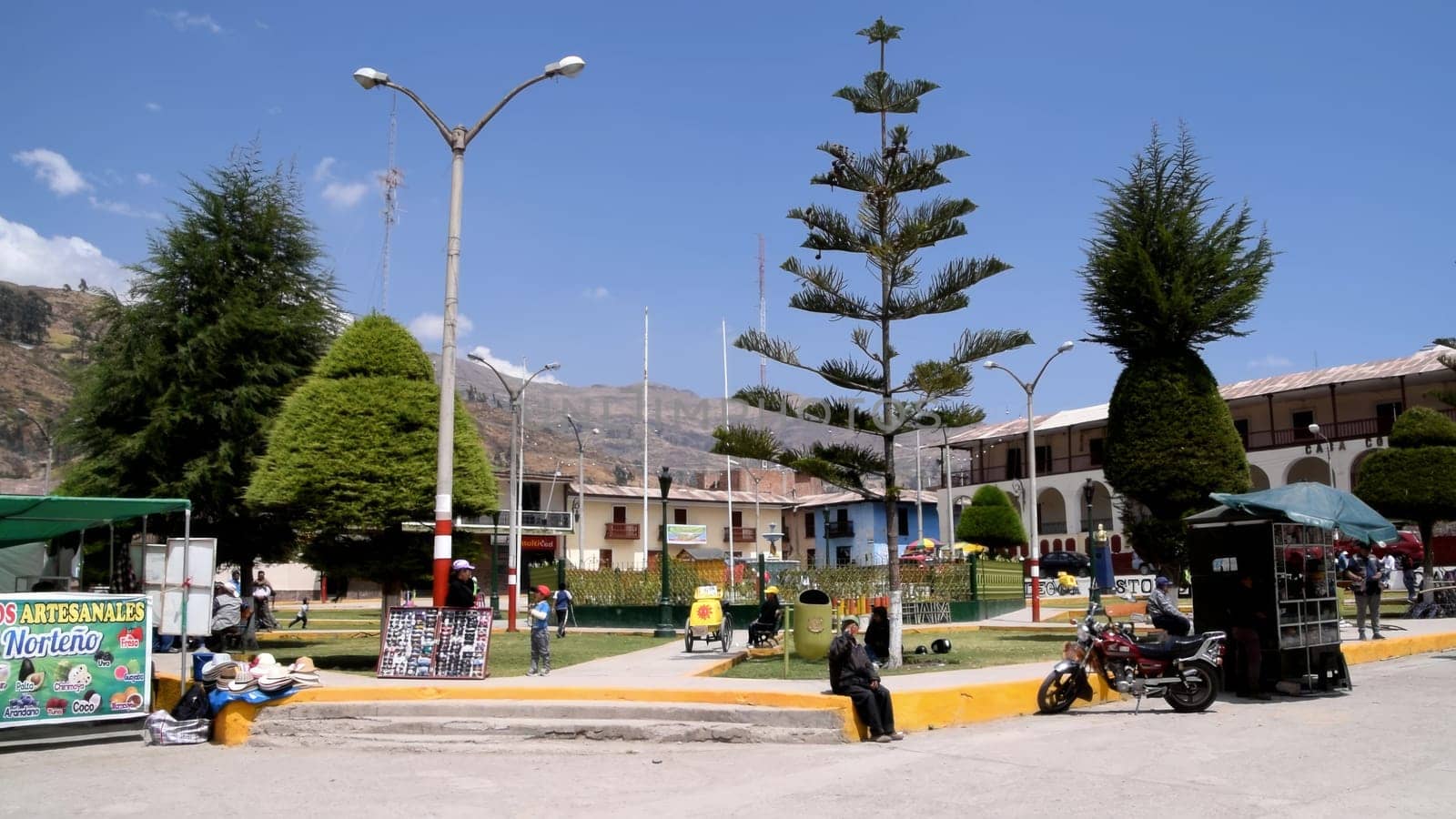 Lima, Peru - September 7, 2019 : Peaceful central park in a small town with locals enjoying a bright day, city of Canta located north of Lima - Peru