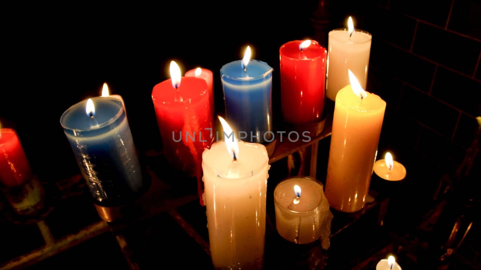 Creating a warm and serene ambiance with assorted colored candlelight for a cozy and intimate evening decoration, perfect for meditation and relaxation in a peaceful and festive atmosphere